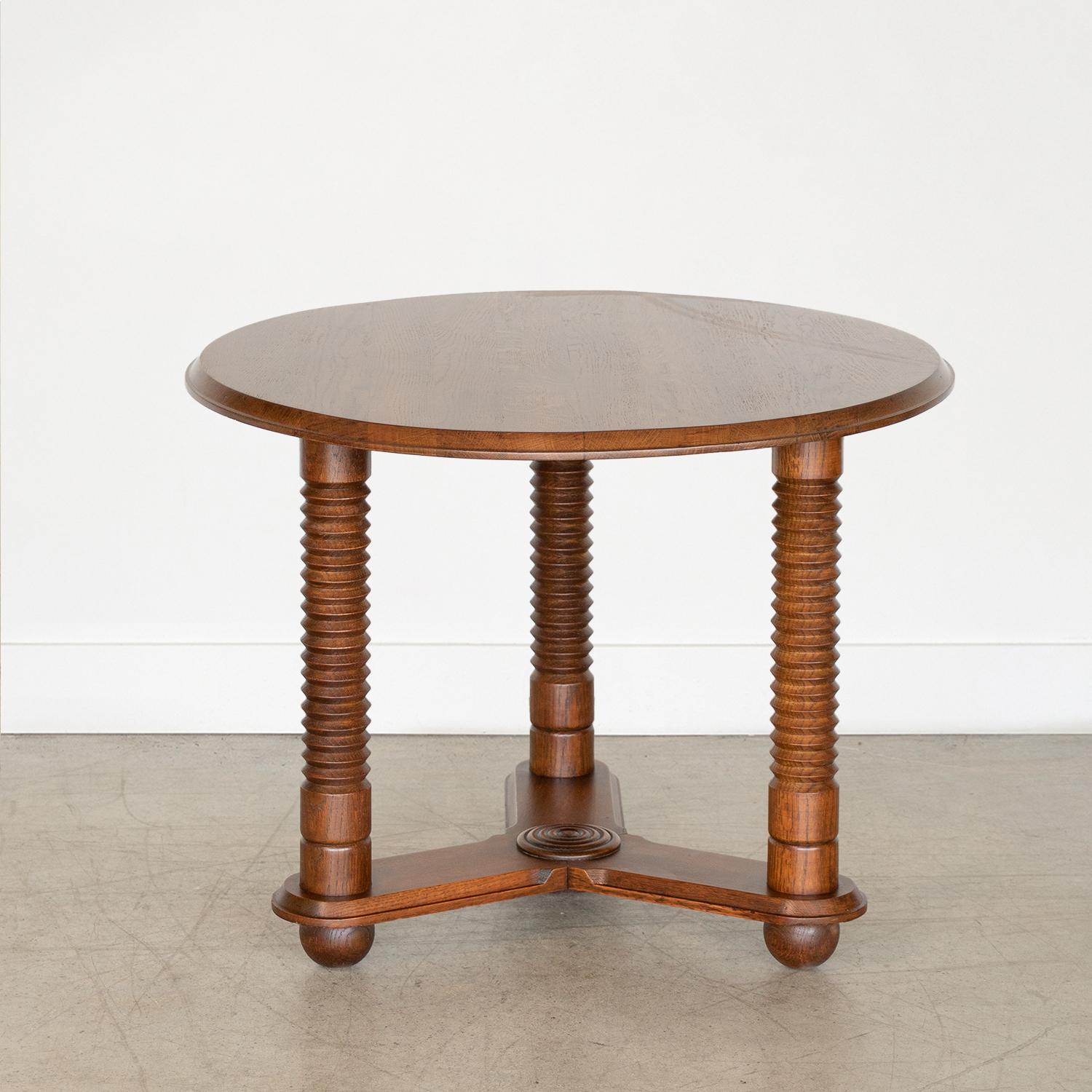 Incredible large wood gueridon table by Charles Dudouyt from France, 1940s. Circular wood top and three leg base with carved legs and ball feet. Medium stain on oak has been refreshed and shows beautiful grain. Stunning statement piece.
