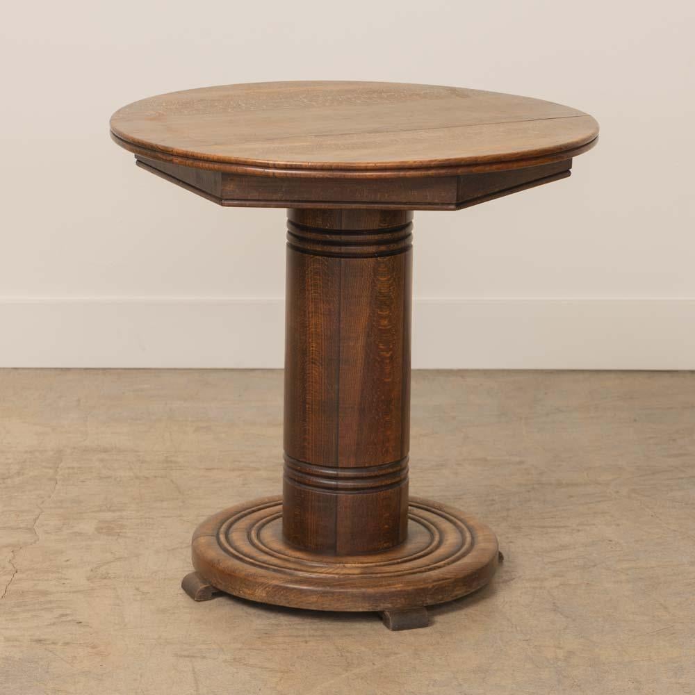 Beautiful carved oak gueridon table from France, 1940's. Circular top with chunky column wood stem and ribbed detailing. Lovely circular base with carved ring detail on four small feet. Original wood finish shows nice age and patina. Perfect between