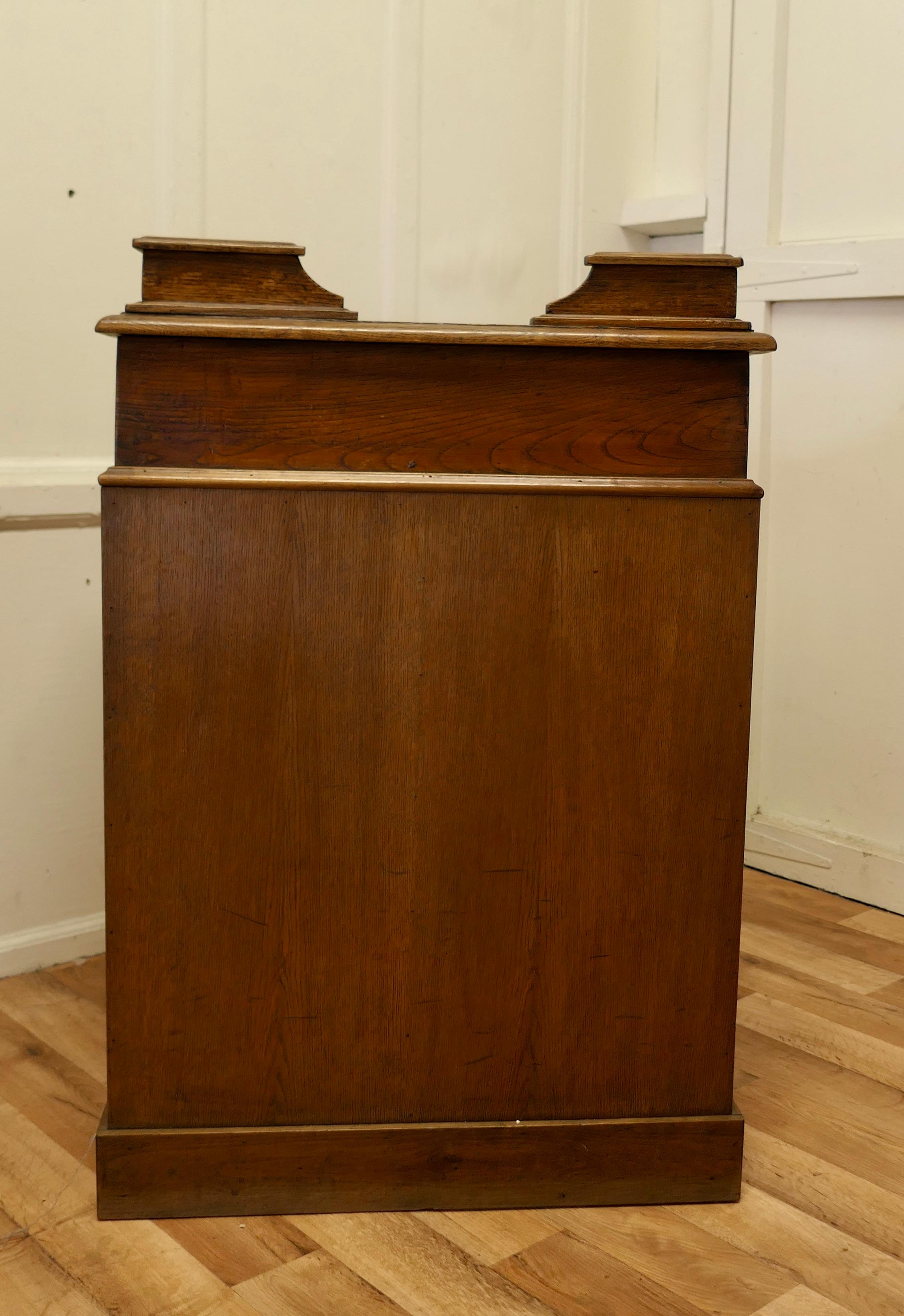 French oak hotel restaurant reception hostess greeting station, greeter

An original French front of house oak greeter, the front and sides of the desk are panelled 
At the reception side there is storage on the interior and there is one cash