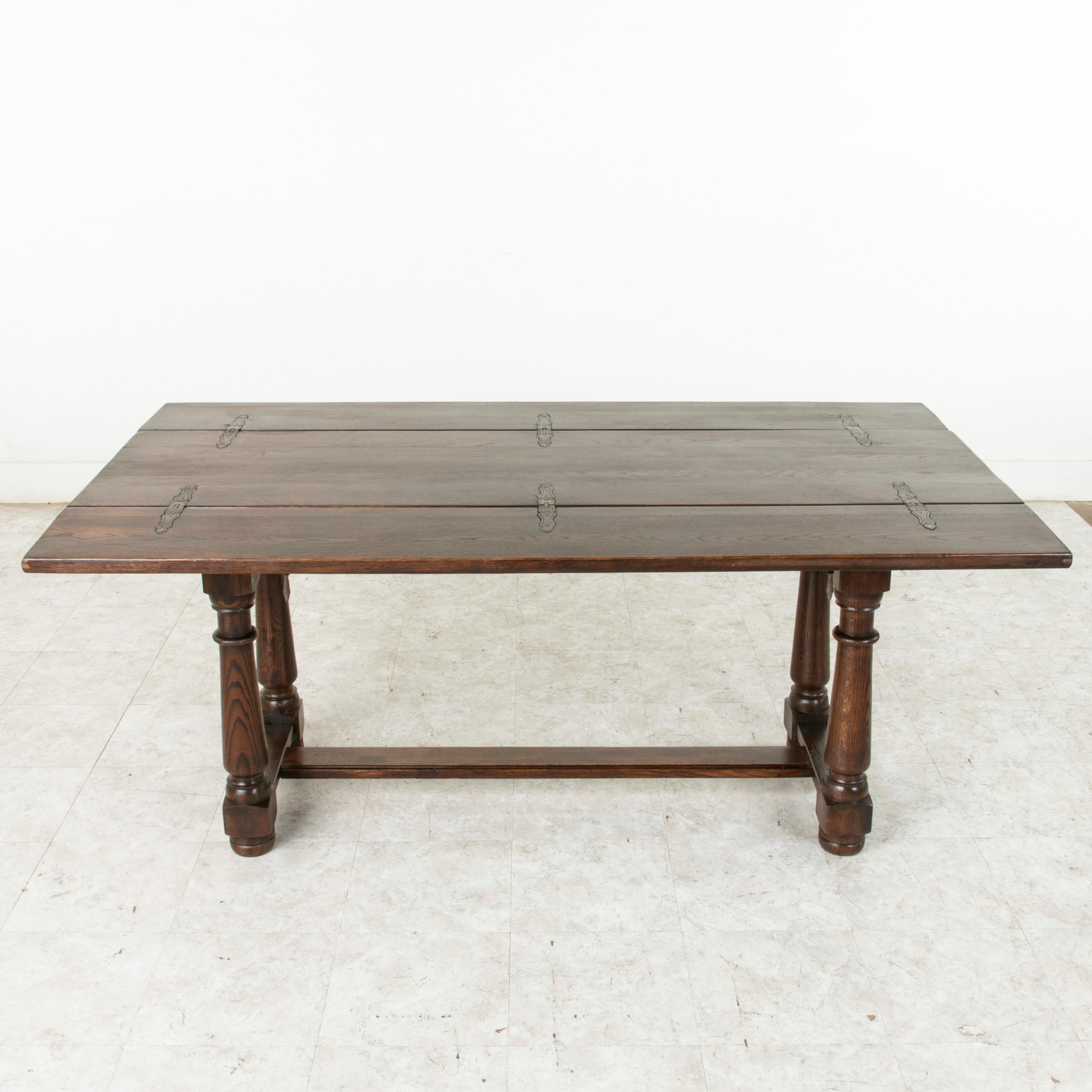Called a table de chasse in French, or hunt table, this French table from the turn of the 20th century was originally designed to lay out the game after the hunt and features a hinged top that allows the surface to double in width when unfolded. The