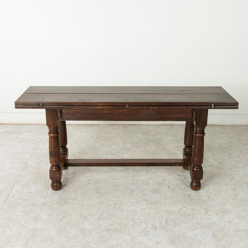 Called a table de chasse in French, or hunt table, this French table from the turn of the 20th century was originally designed to lay out the game after the hunt and features a hinged top that allows the surface to double in width when unfolded. The
