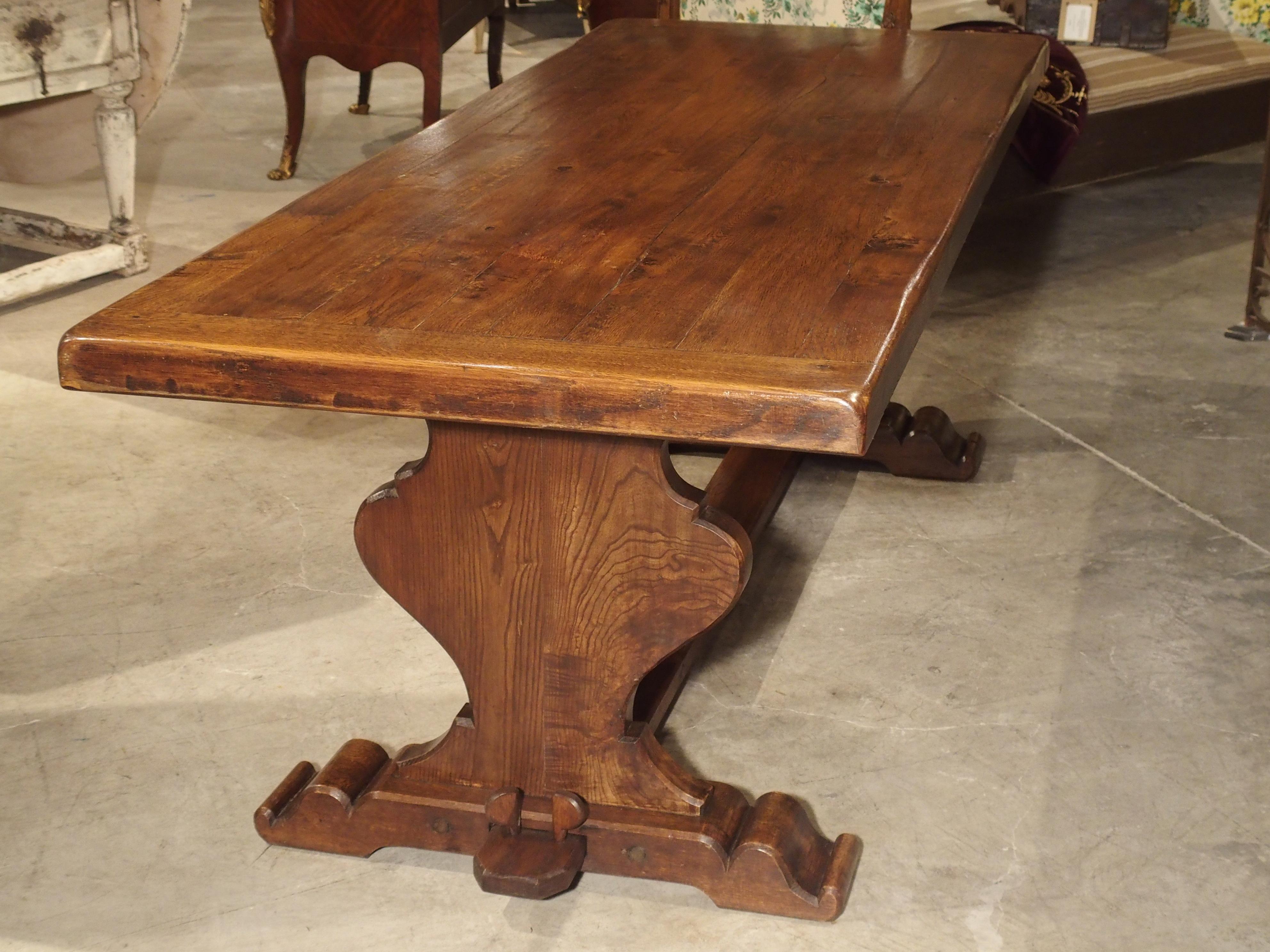 From France, comes this fabulous French oak monastery style dining table from the early 1900’s. The top is made of a series of long, thick oak boards and a peripheral surround. The legs are an elegant solid lyre shape and rest upon stabile platform