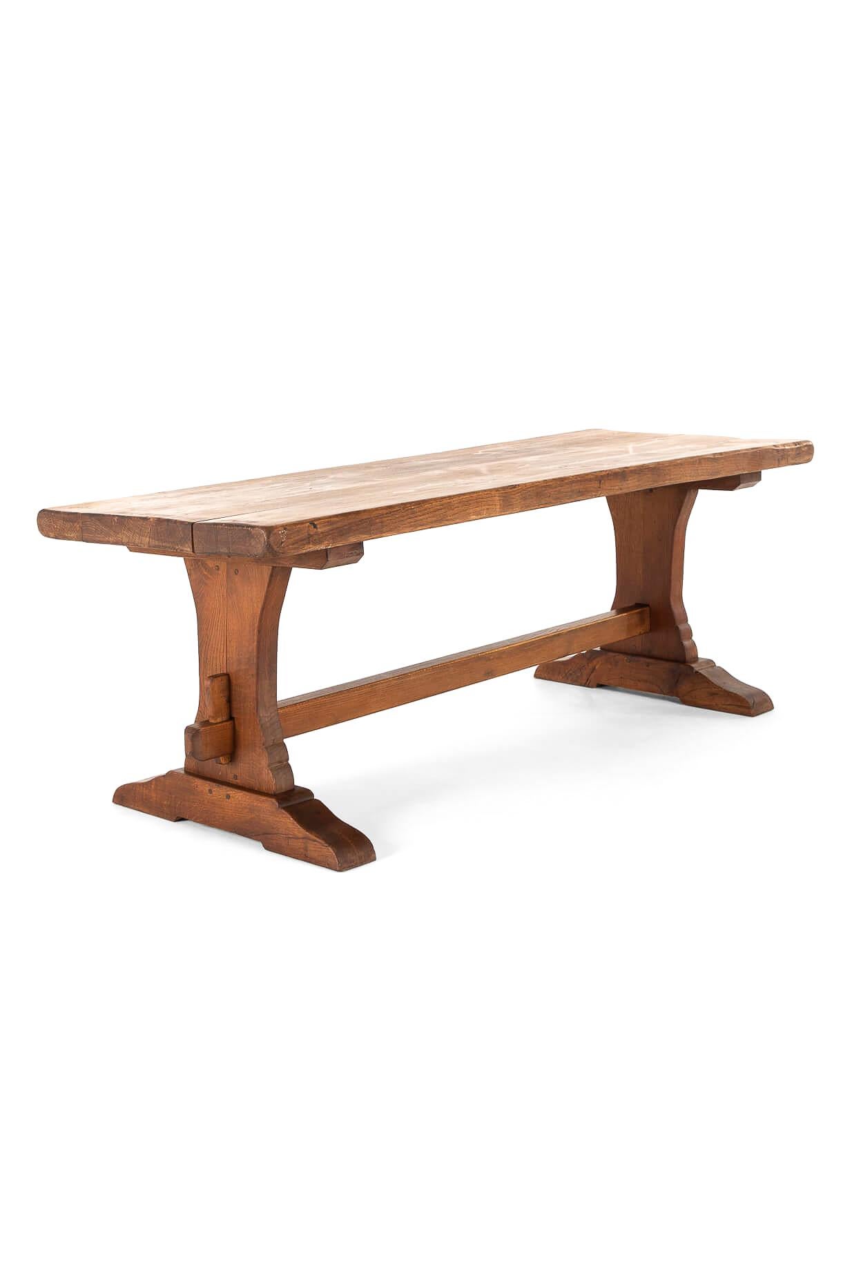 A superb French oak monastery table with a generous three-plank top.

The top is supported on a large trestle base, and united with a single stretcher secured at each end with oak pegs.

The sturdy table is expertly crafted, strengthened with