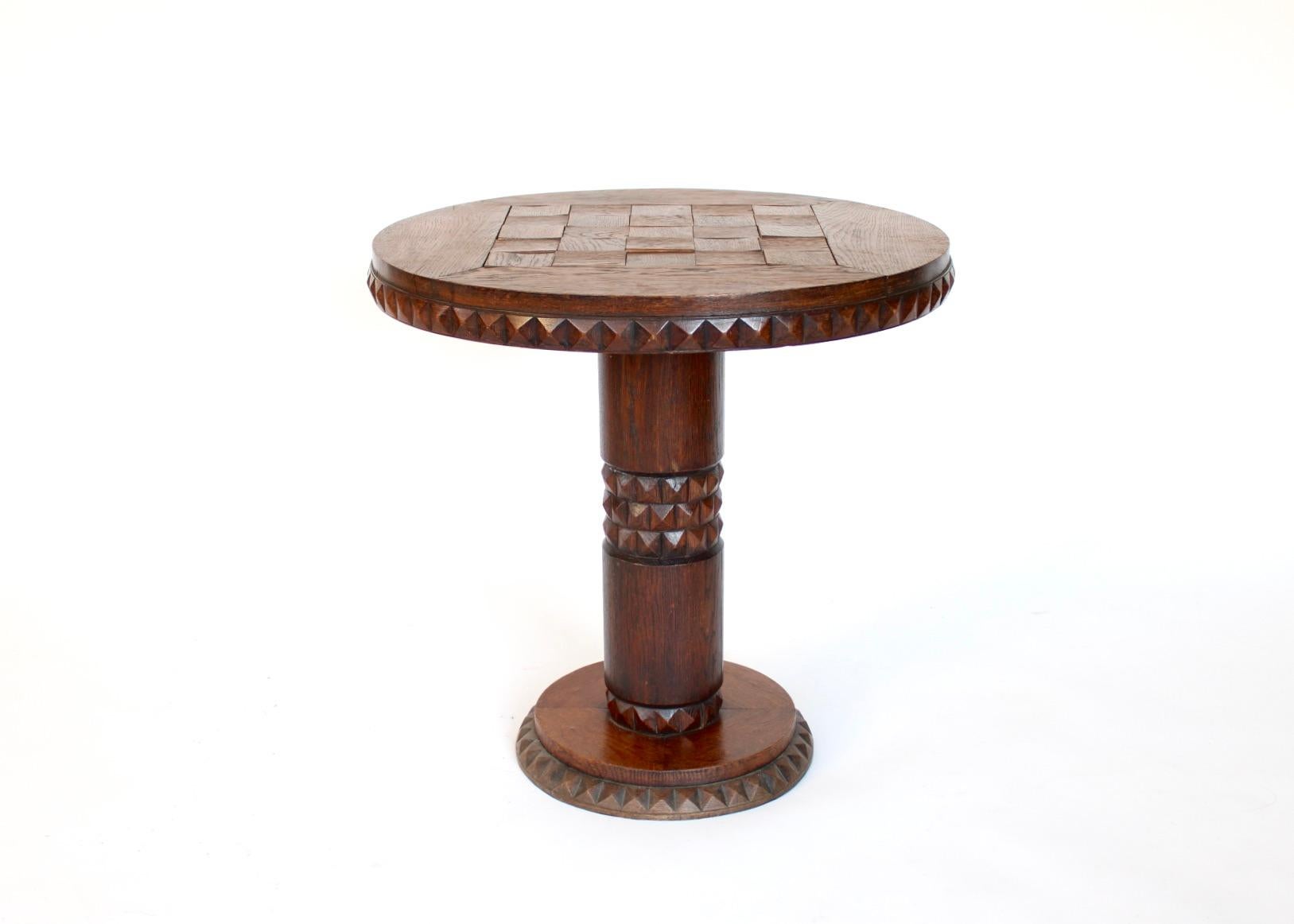 Sculptural French Art Deco period or c1940 carved side table. Hand carved individual diamond pyramid faceted motif oak embellishments along the edge. Each in prefect original condition. The motif continues on the column midway with 3 rows of the