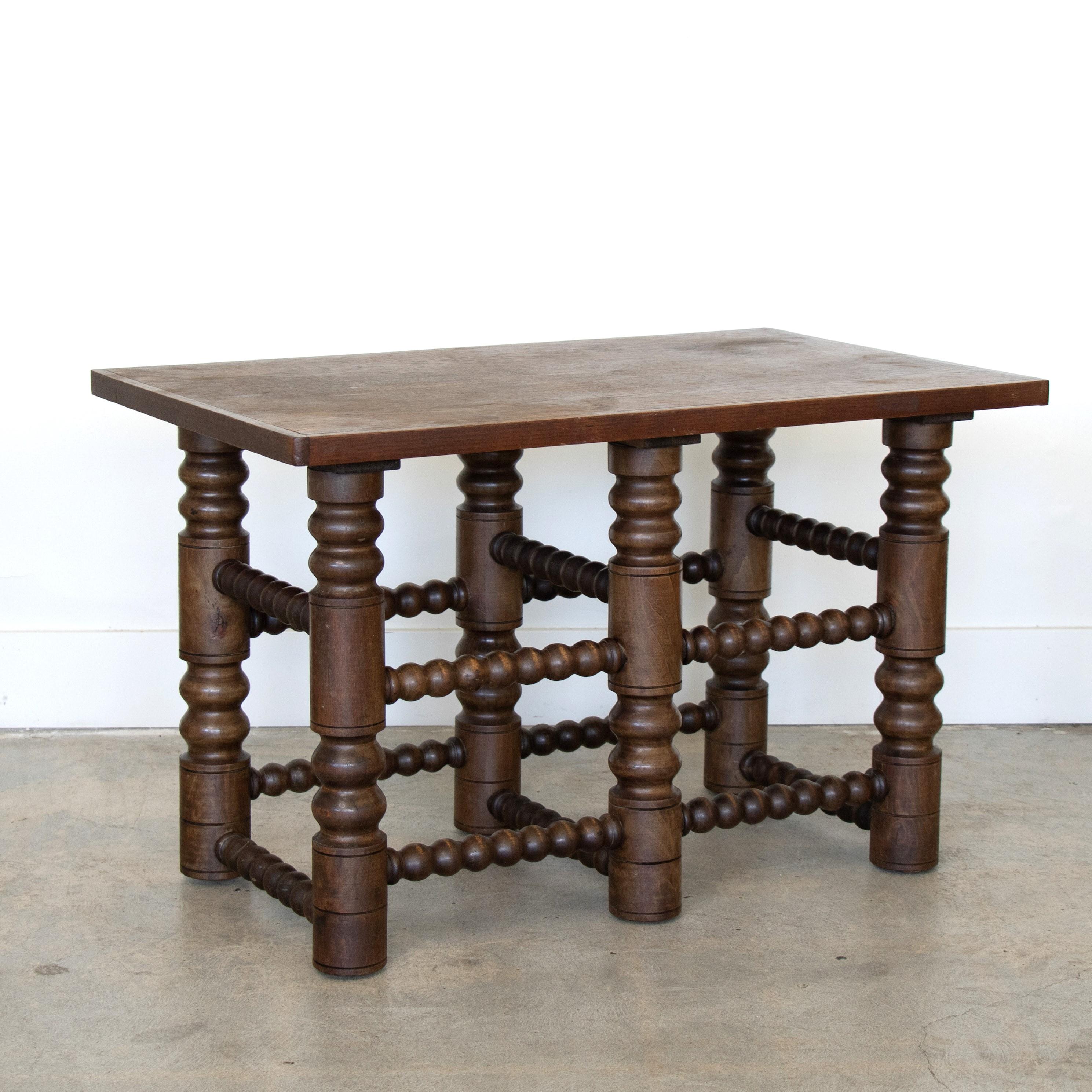Incredible French dark oak wood coffee table in the style of Charles Dudouyt, 1940's. Rectangular top with intricately carved legs and crossbars. Perfect as a small coffee table or side table. Original wood finish shows great patina and age. 