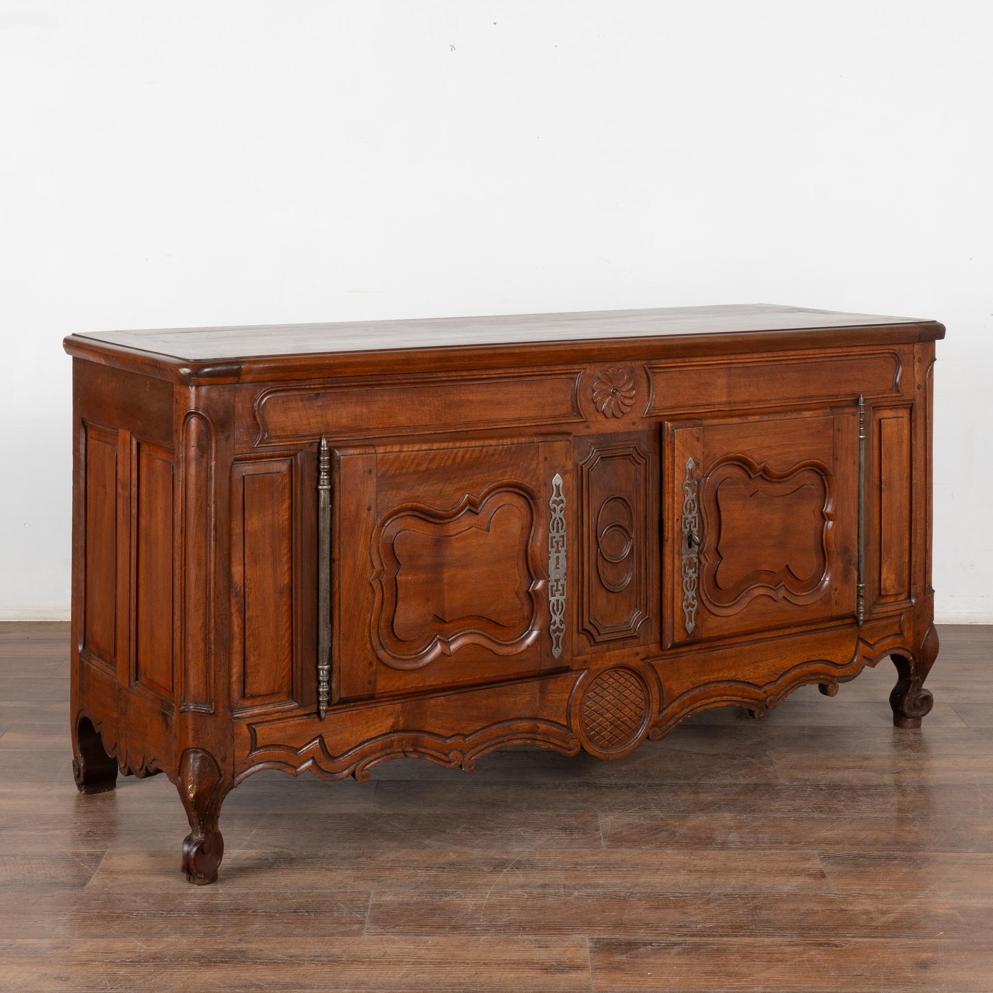 French oak sideboard with traditional carved panel details and scalloped skirt. The deep, rich patina of the wood reflects generations of use. At just under 6' long, this will serve well as a buffet or console. 
Restored, strong, stable and ready