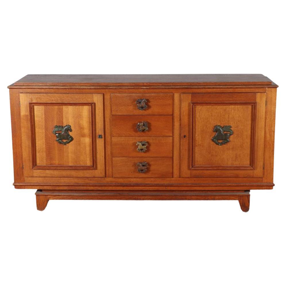 French oak sideboard circa 1940 having two doors and four drawers.  For Sale