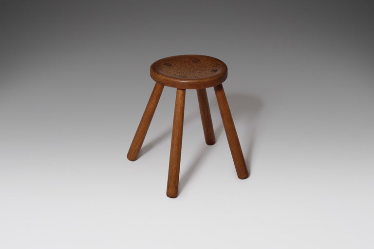 Nice and sturdy oak stool, France, 1950s. The seat of the stool is nicely decorated with deep carvings, all handcrafted. The legs of the stool stand wide out and come true the seating. All together making it an adorable and decorative piece. The