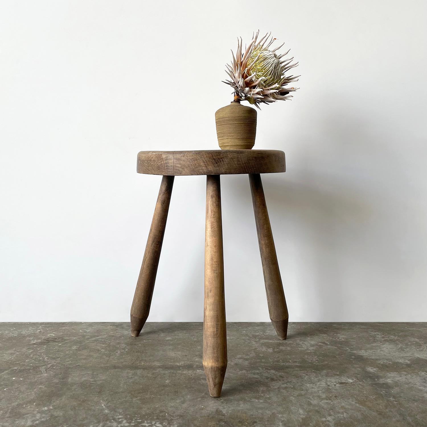 French oak tripod side table in the style of Perriand
France, early 20th century
This piece is rich with character and charm from years of life
Beautiful wood grain and original finish
Neutral toned palette with smoky brown undertones accented with