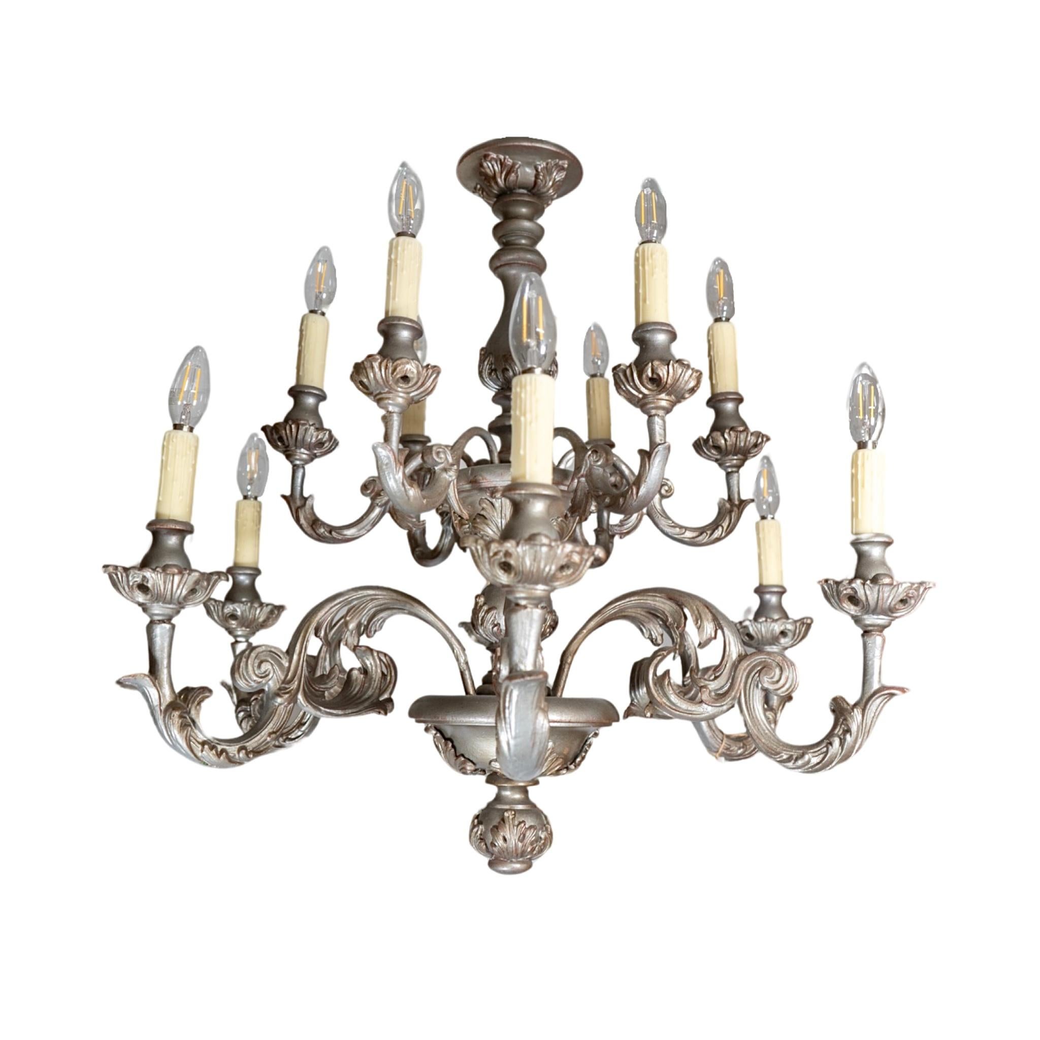 Crafted from French Oak wood in the 1970s, this chandelier boasts a timeless elegance with its silver leaf finish. Expertly wired and ready for installation, it brings a touch of luxury to any space. Elevate your décor with this unique and rare find.