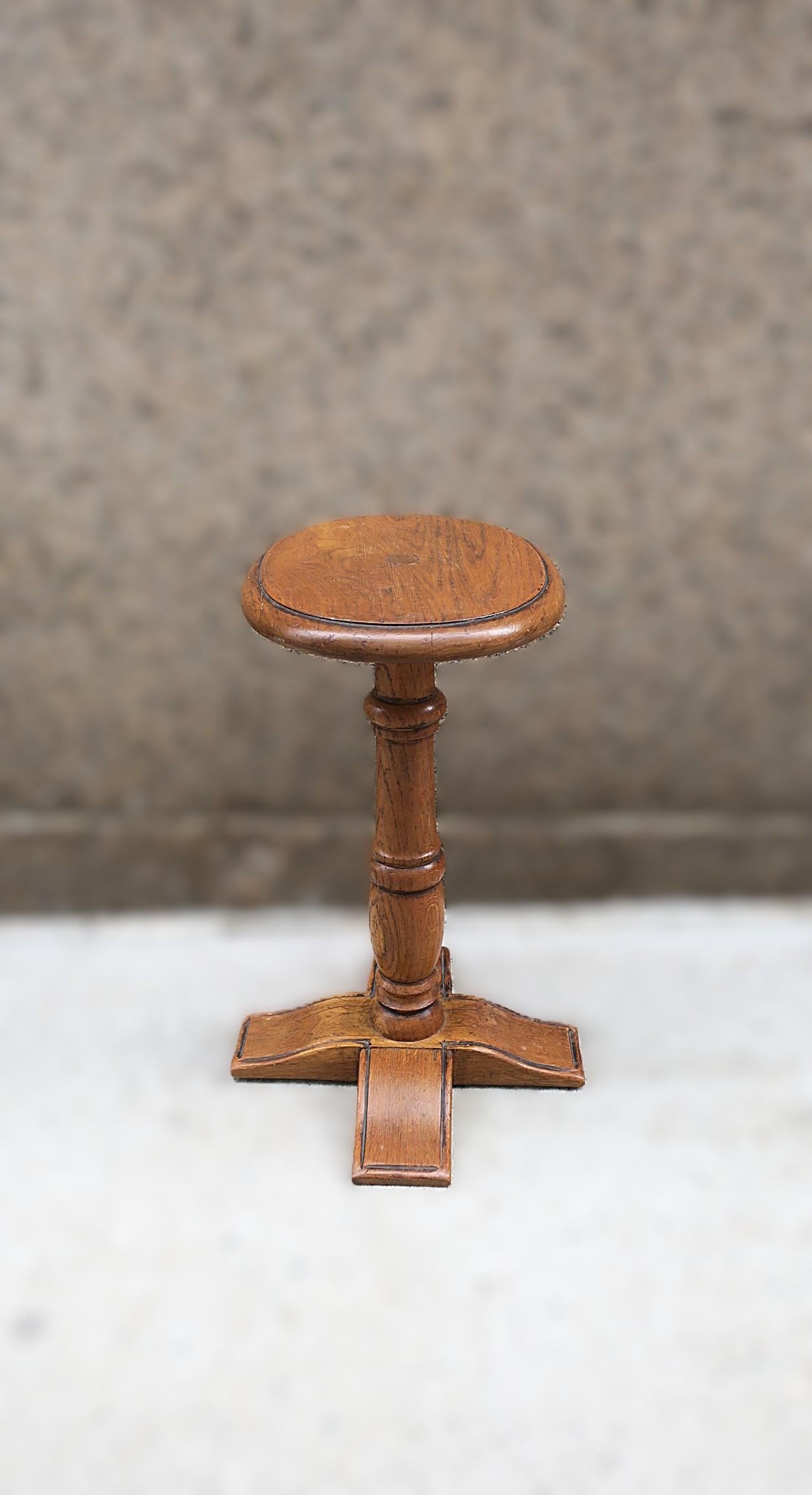 A French oak wood side or drinks table, circa early to mid-20th century, France. Made in France as marked (twice) on underside as shown in last three (3) image. Table has an oval top, turned wood neck, finished with a four leg base. Table is a