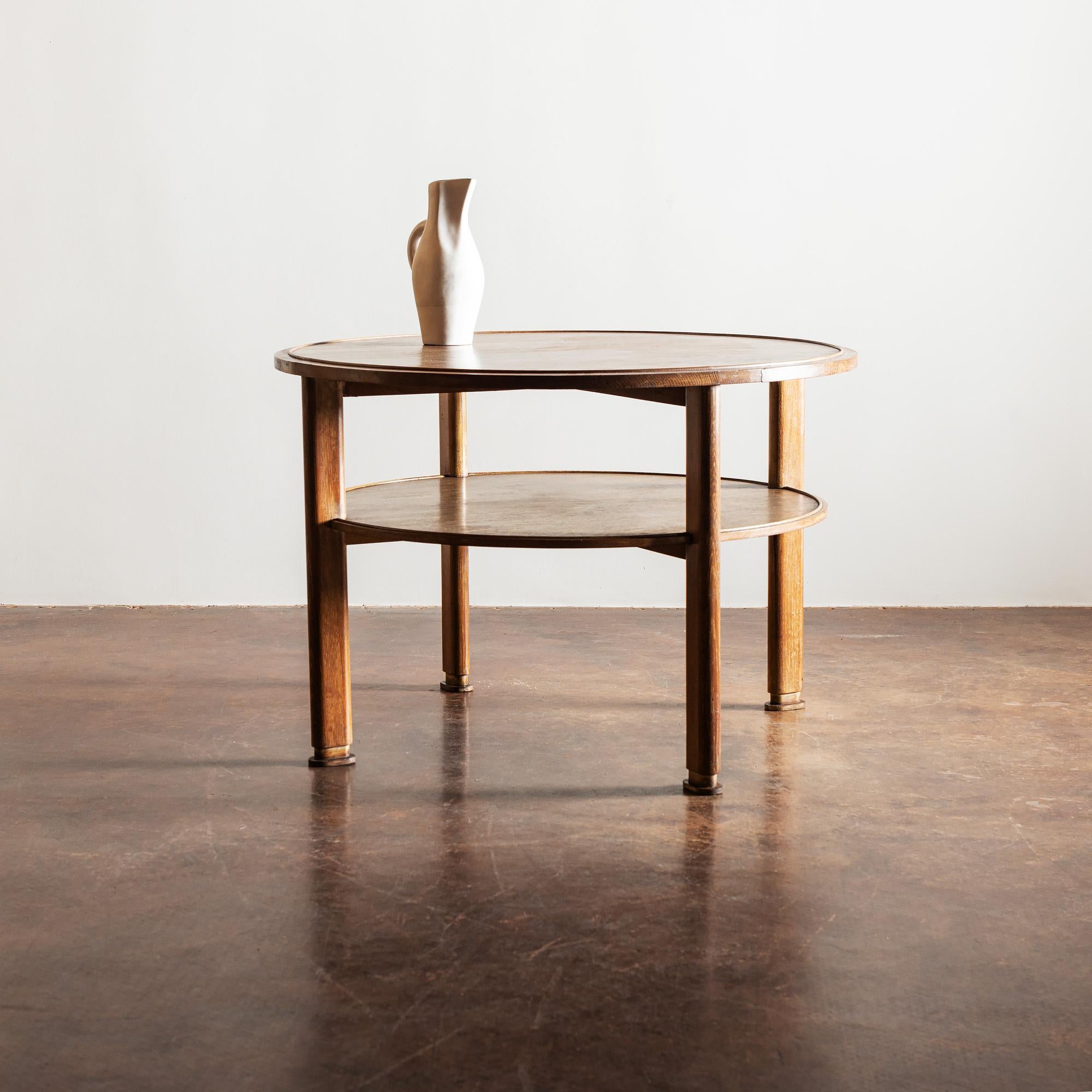 Handsome and versatile two-tiered occasional table in cerused oak, in the manner of Jacques Adnet, France, 1940s.
