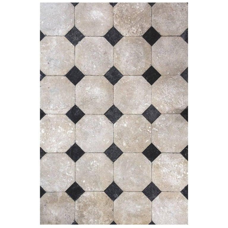 French octagonal flooring sample.

Classically French, this black and white limestone flooring is what one might find in a grand chateau or manor house in Europe. 
This style of French flooring dates circa 1750s, these octagonal tiles lay together