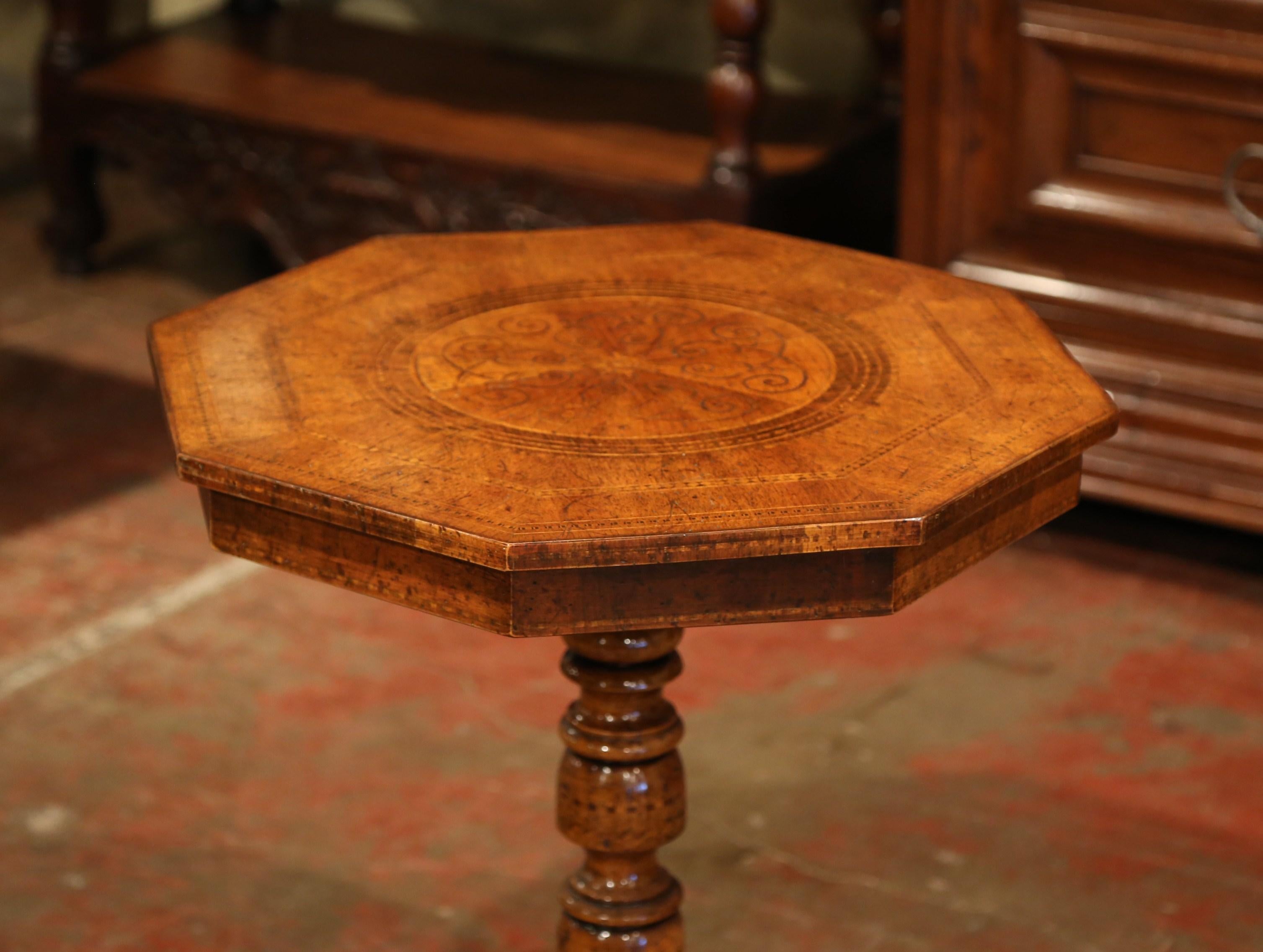 Incorporate extra surface space into your living room with this French fruit wood gueridon table. The octagonal gueridon could easily be placed next to a sofa or between two armchairs given its height and versatile shape. Standing on a carved base