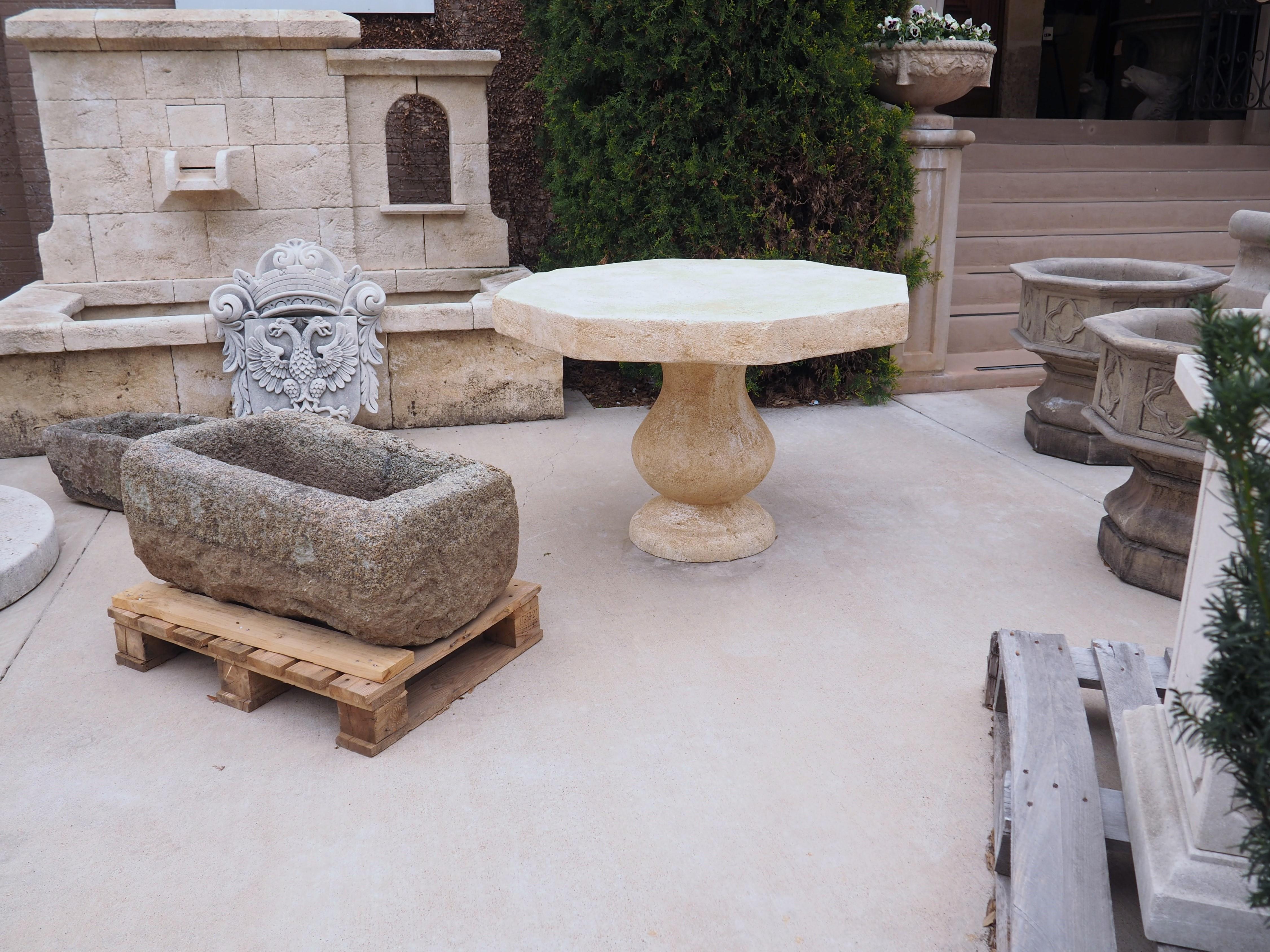 This versatile, hand carved, octagonal stone table from France can be used outside as well as inside. It is made of French estaillade limestone, which has been used for centuries in the creation of outdoor pieces. When the limestone is quarried, it