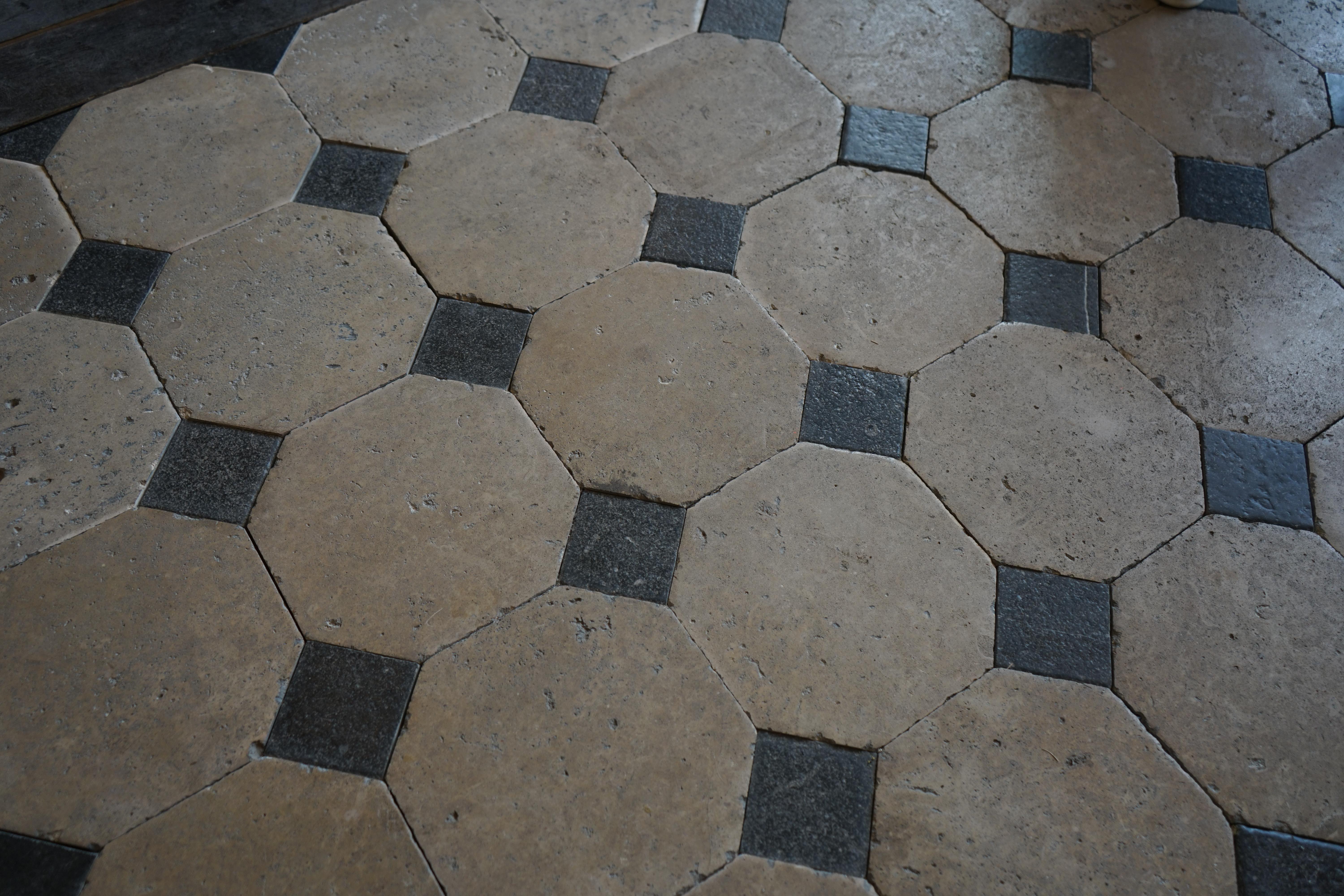Classically French, this black and white limestone flooring is what one might find in a grand chateau or manor house in Europe. This style of French flooring dates circa 1750s, these octagonal tiles lay together to create a unique floor arrangement