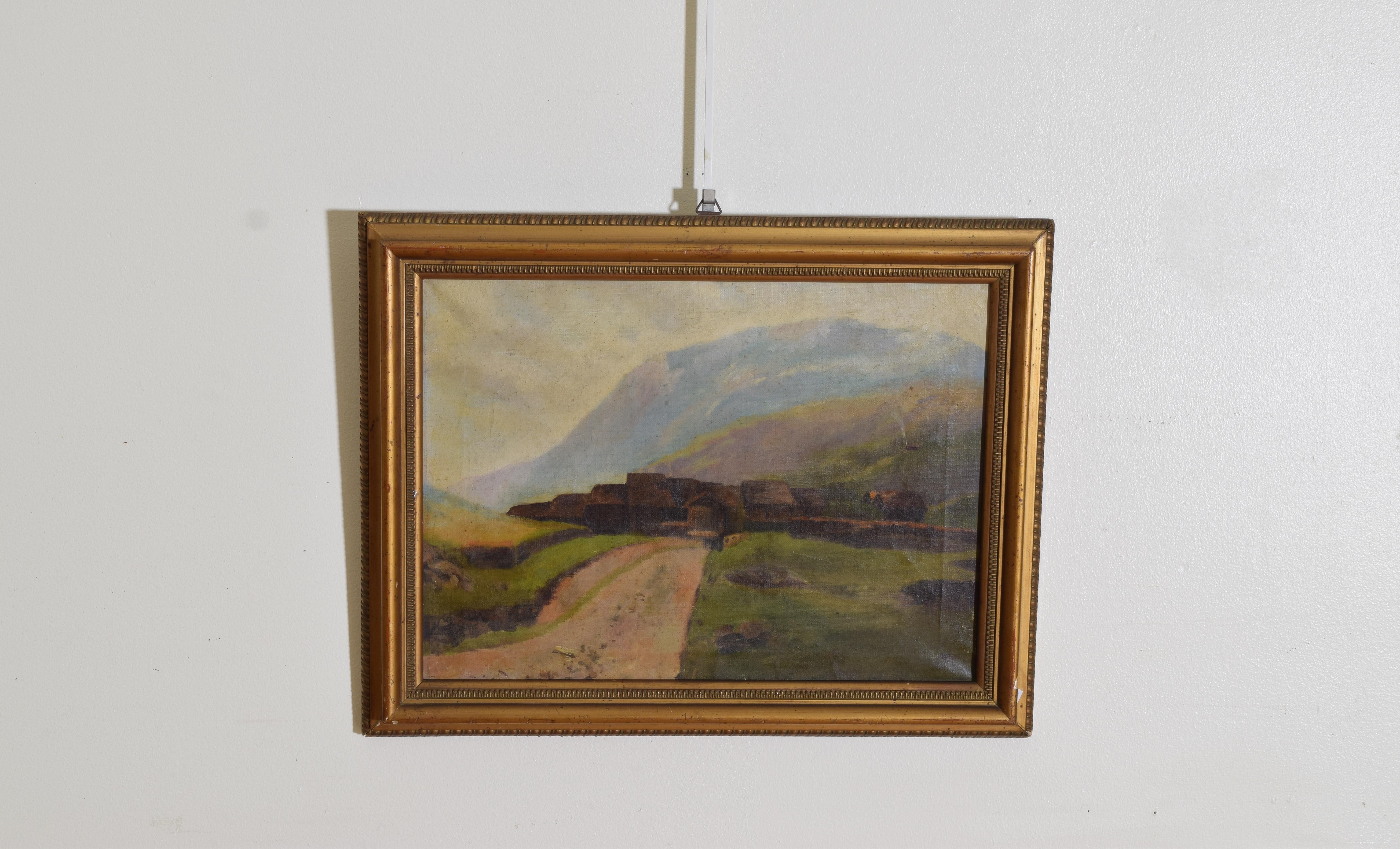 Depicting a worn road through a pasture toward a thatch roofed village with mountains in the background, in a period giltwood frame