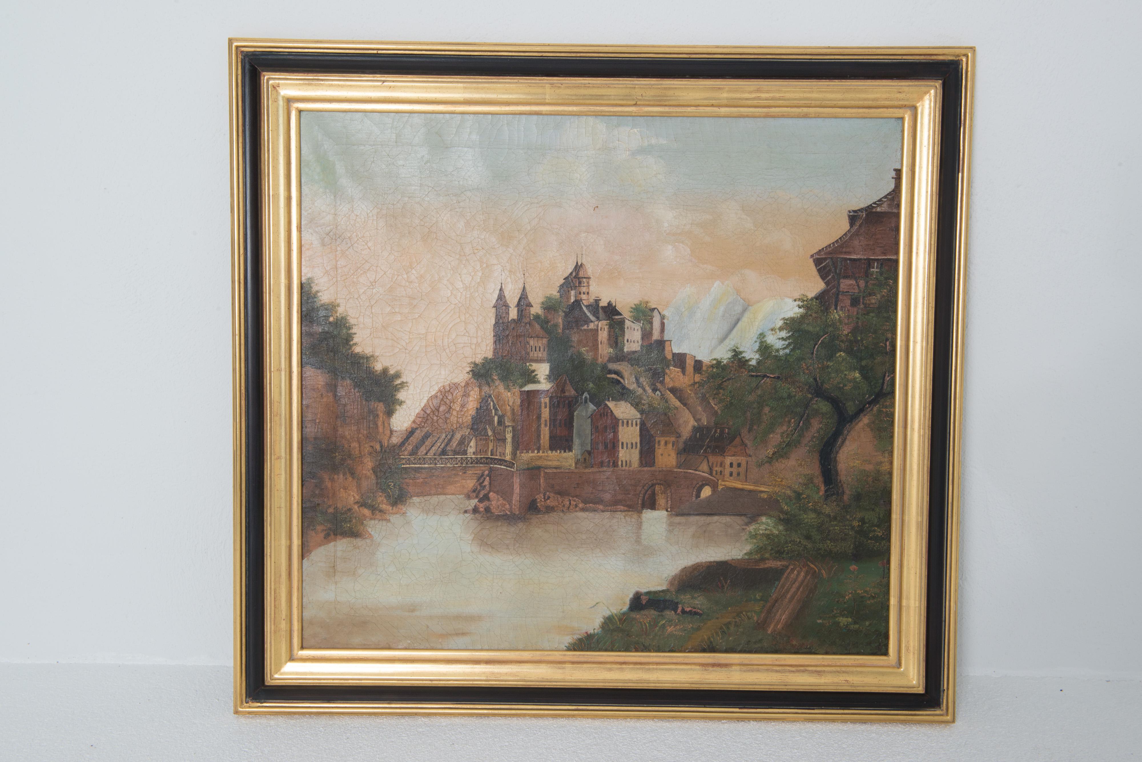 A charming oil painting on canvas depicting a French village on a hill with a castle 
atop the hill. Framed in a good quality gilt and black lacquered wood frame.