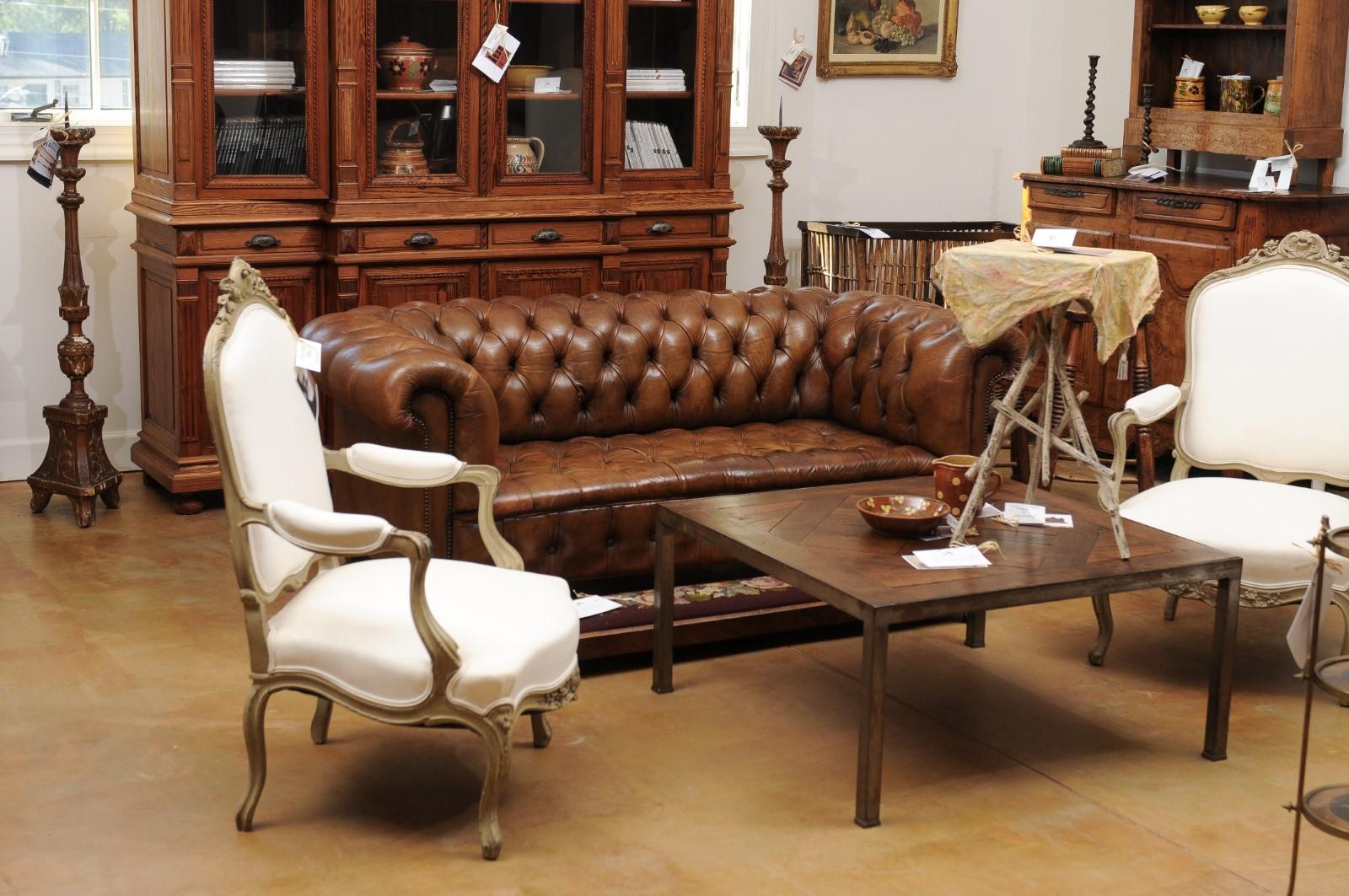 A French tufted leather Chesterfield sofa with nailhead trim from the late 19th century. This French canapé features the traditional shape of Chesterfield sofas with its straight back that was designed to allow gentlemen to sit upright, and its