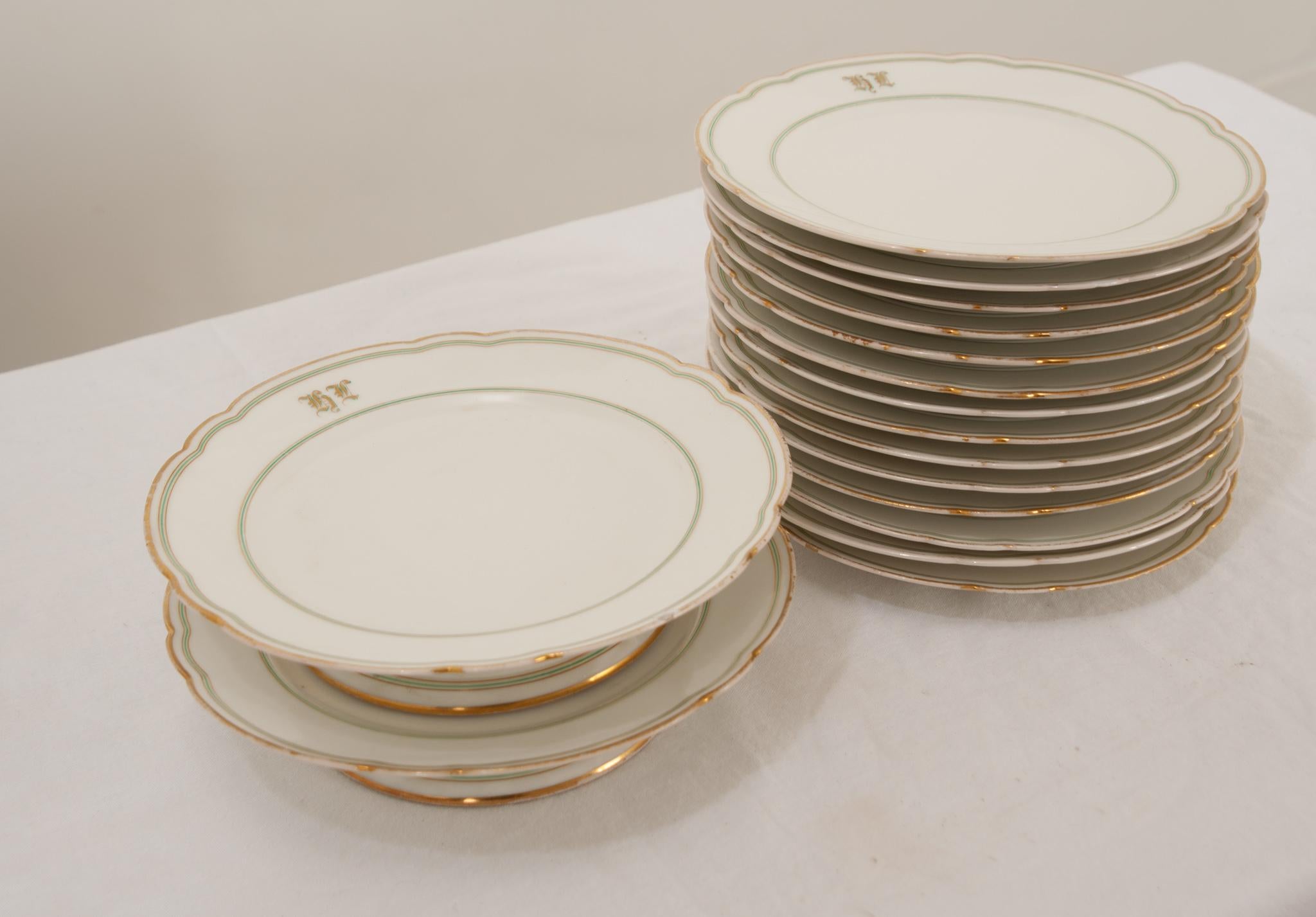 This charming 16 piece Old Paris service will elevate your dining experience to the next level. Vibrant green rings and initials “KL” are accented with gold. On the back of each plate is the maker's initials and location are marked in red cursive-