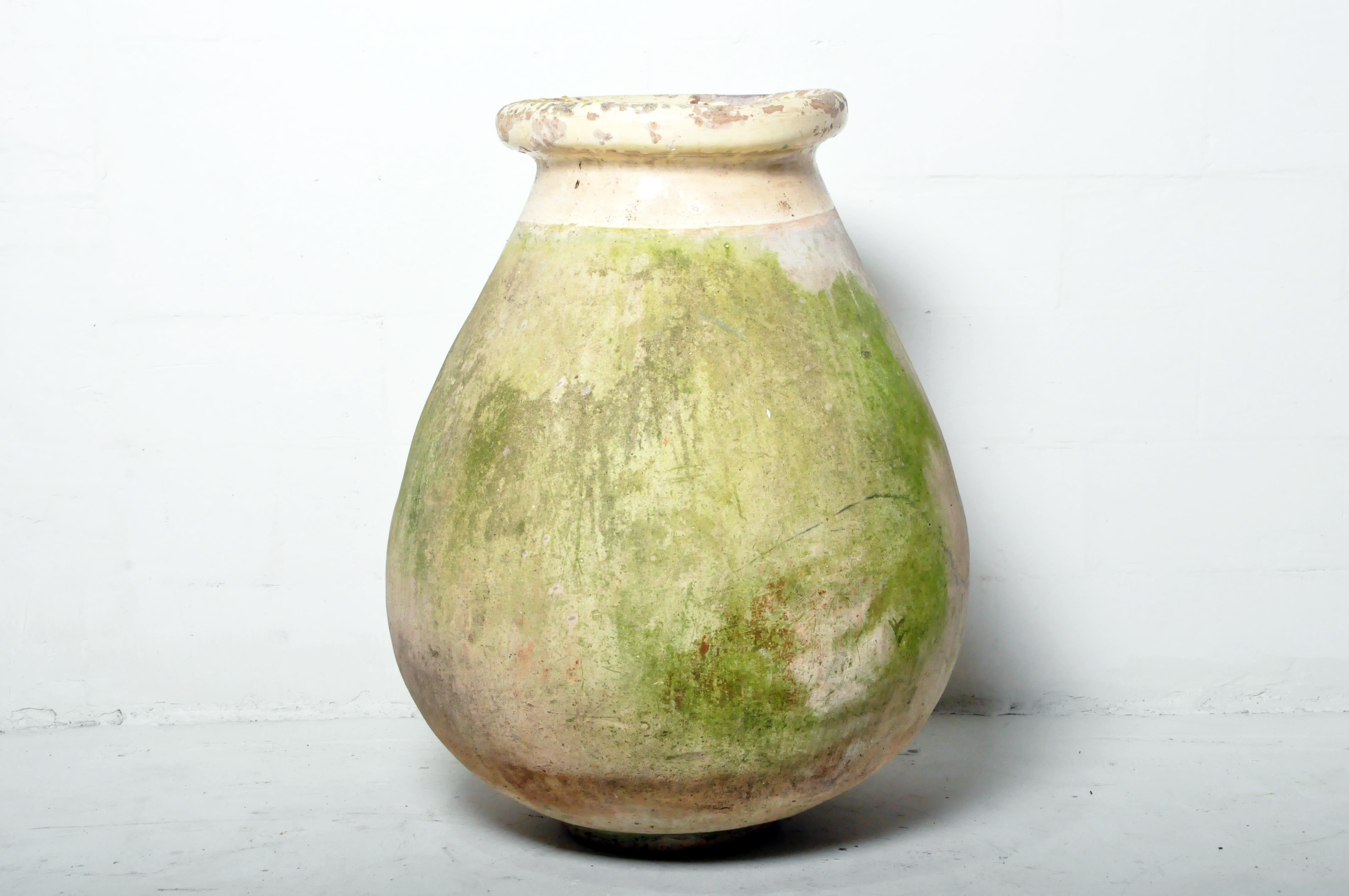 This monumental jar was once used to store and transport large quantities of olives. This rotund style is typical of the Provence region of France. Wear consistent with age and use.
 