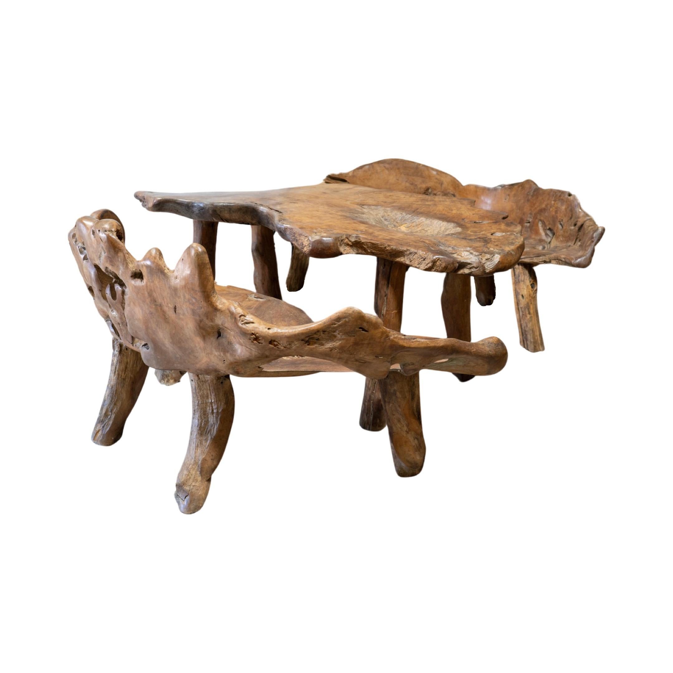 This unique garden table set is crafted from a 19th century French olive tree, providing a one-of-a-kind piece for any outdoor or indoor space. The set includes a table and two wide bench-style chairs, perfect for creating an earthy and inviting