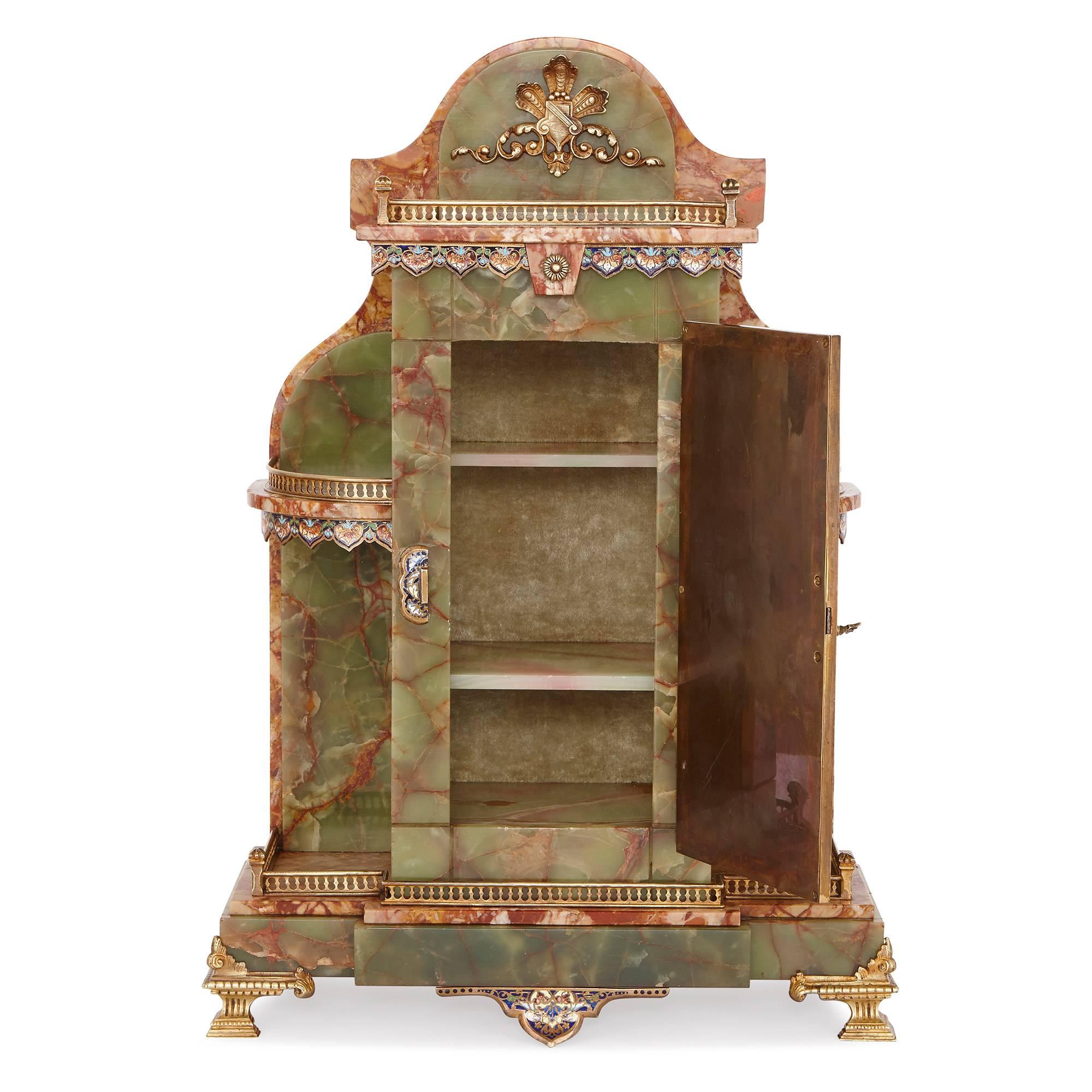 This elegant dressing table cabinet uses precious materials on a delicate scale, resulting in a piece that is both practical and luxurious. 

The cabinet is crafted in green onyx and set with contrasting pink, veined marble, and has an