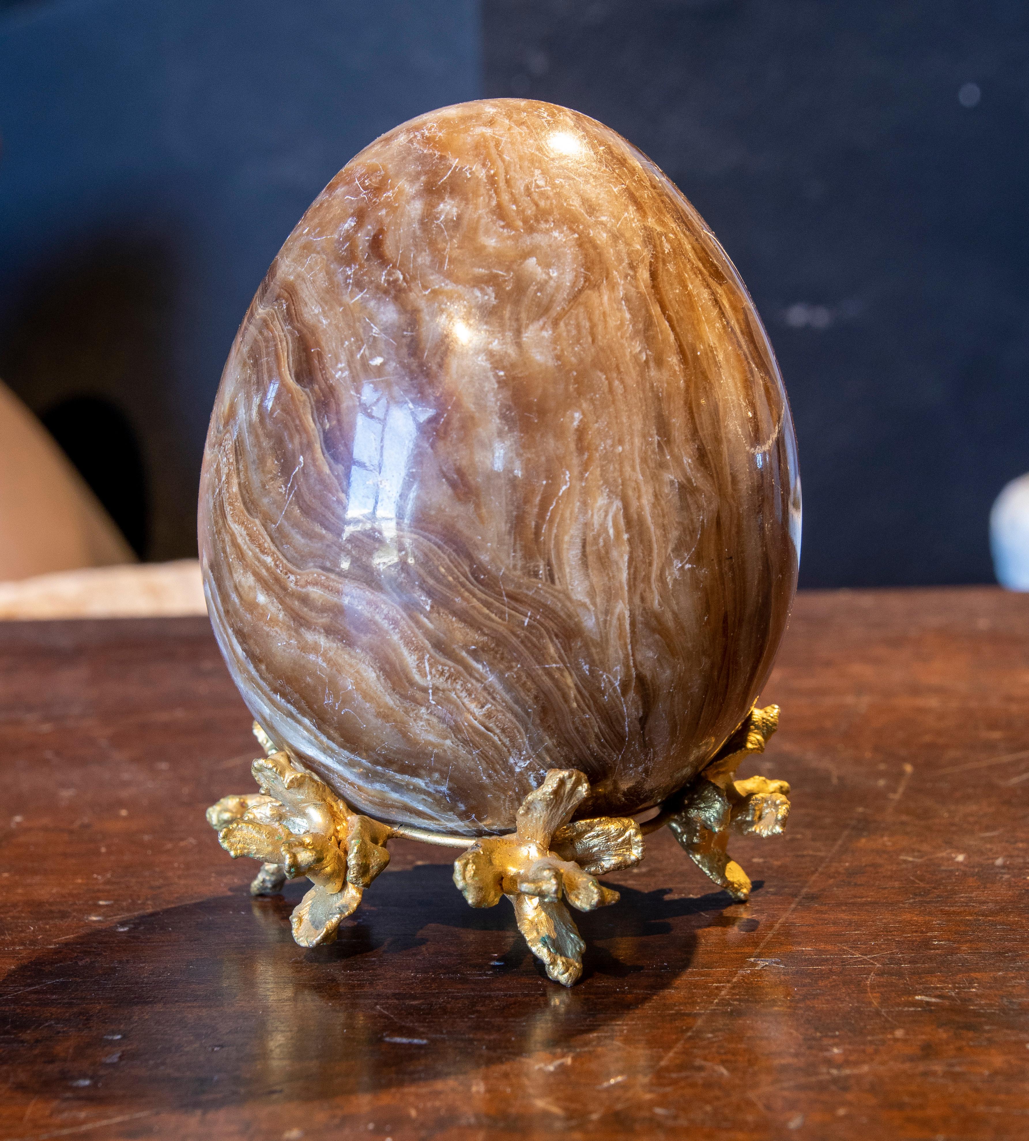 French onyx egg shaped paperweight with bronze base.