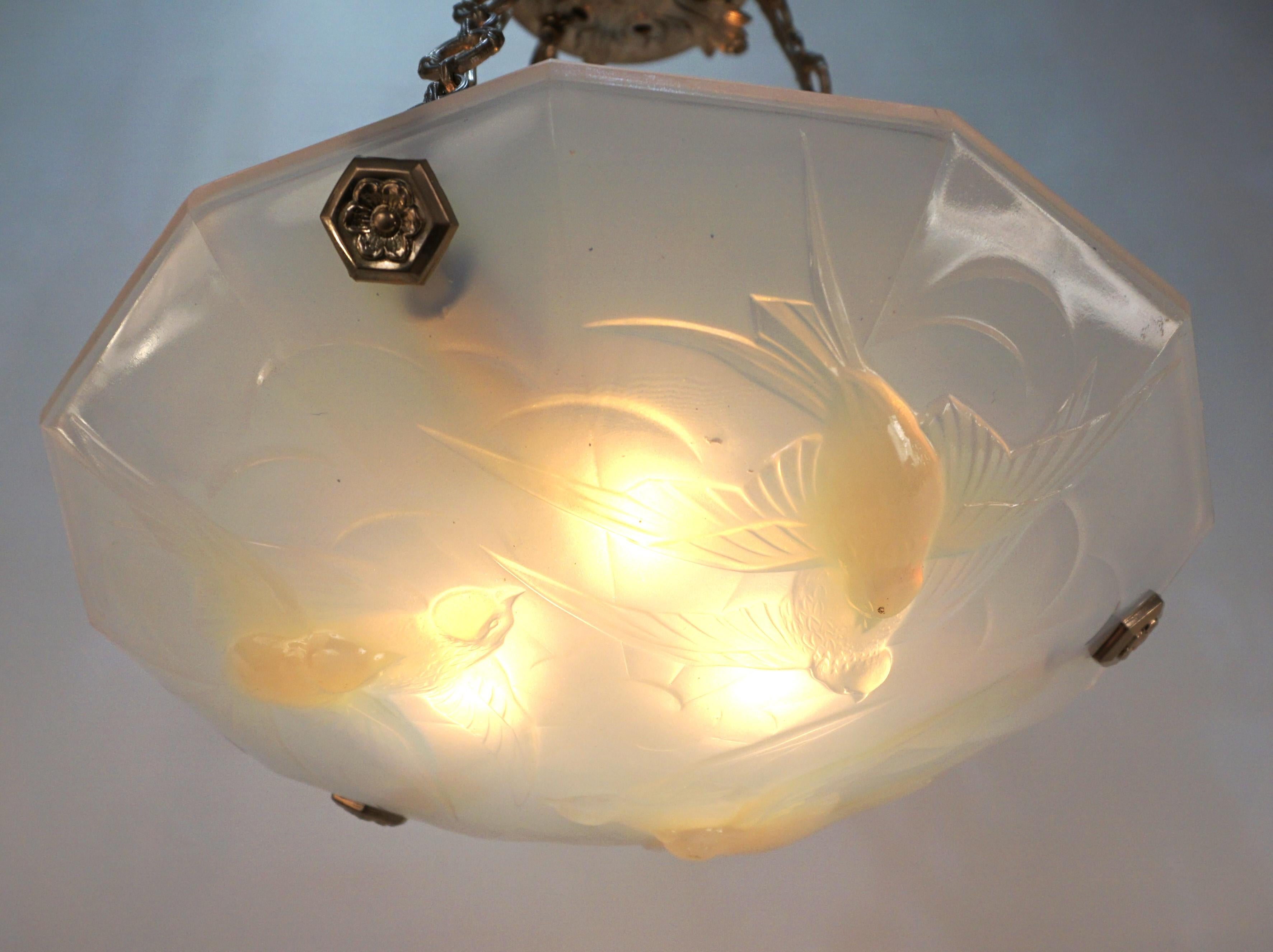 Light honey blue frost opal glass birds in flying motion chandelier with nickel on bronze chain and hardware.
Professionally rewired and ready for installation.
Six lights, 60 watts max each.