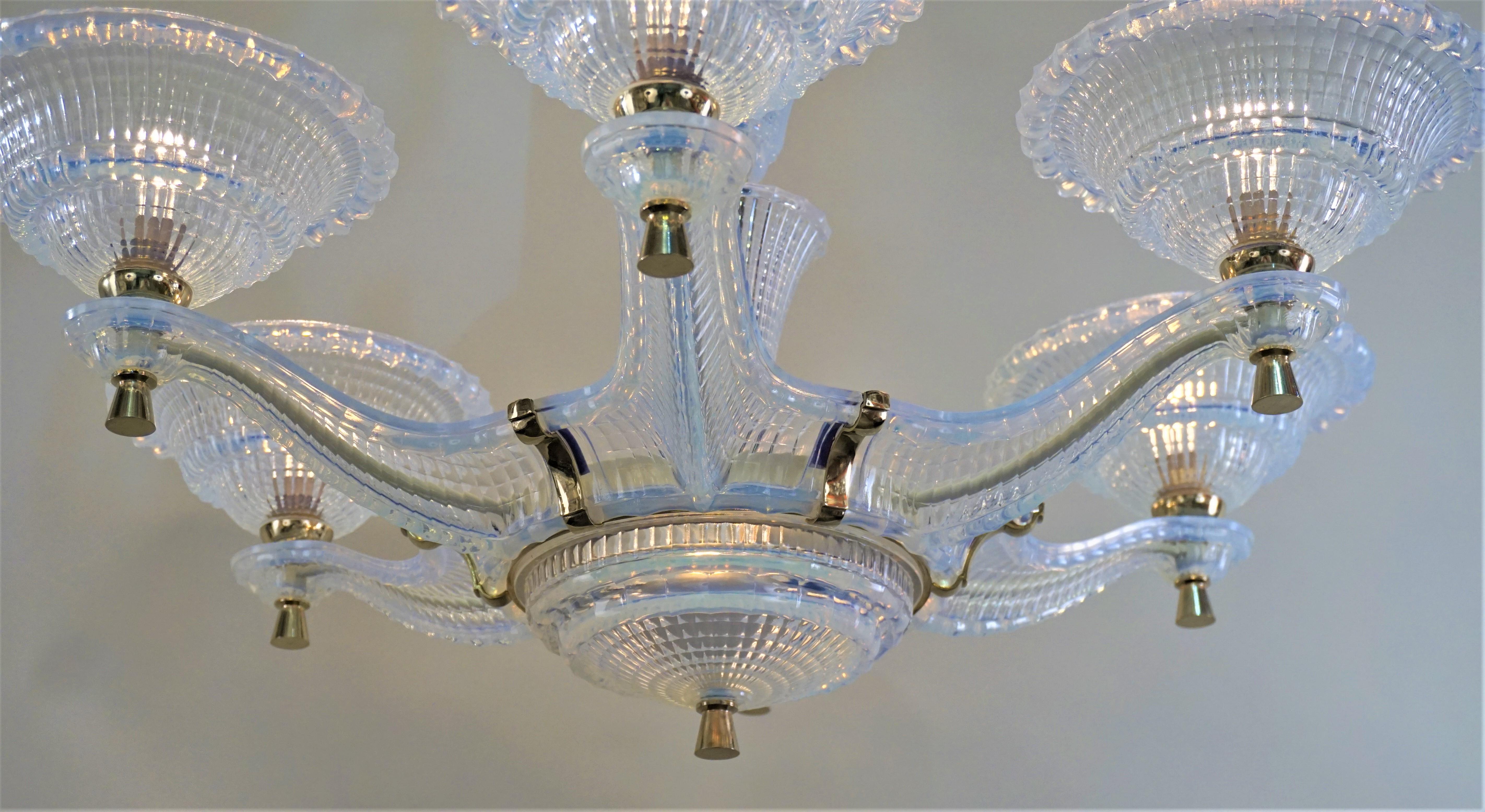 An stunning Art Deco chandelier. Made during 1930s this six-arm eight-light chandelier is entirely made of opalescent glass except some polished bronze hardware and canopy.
60 watt max each light.
