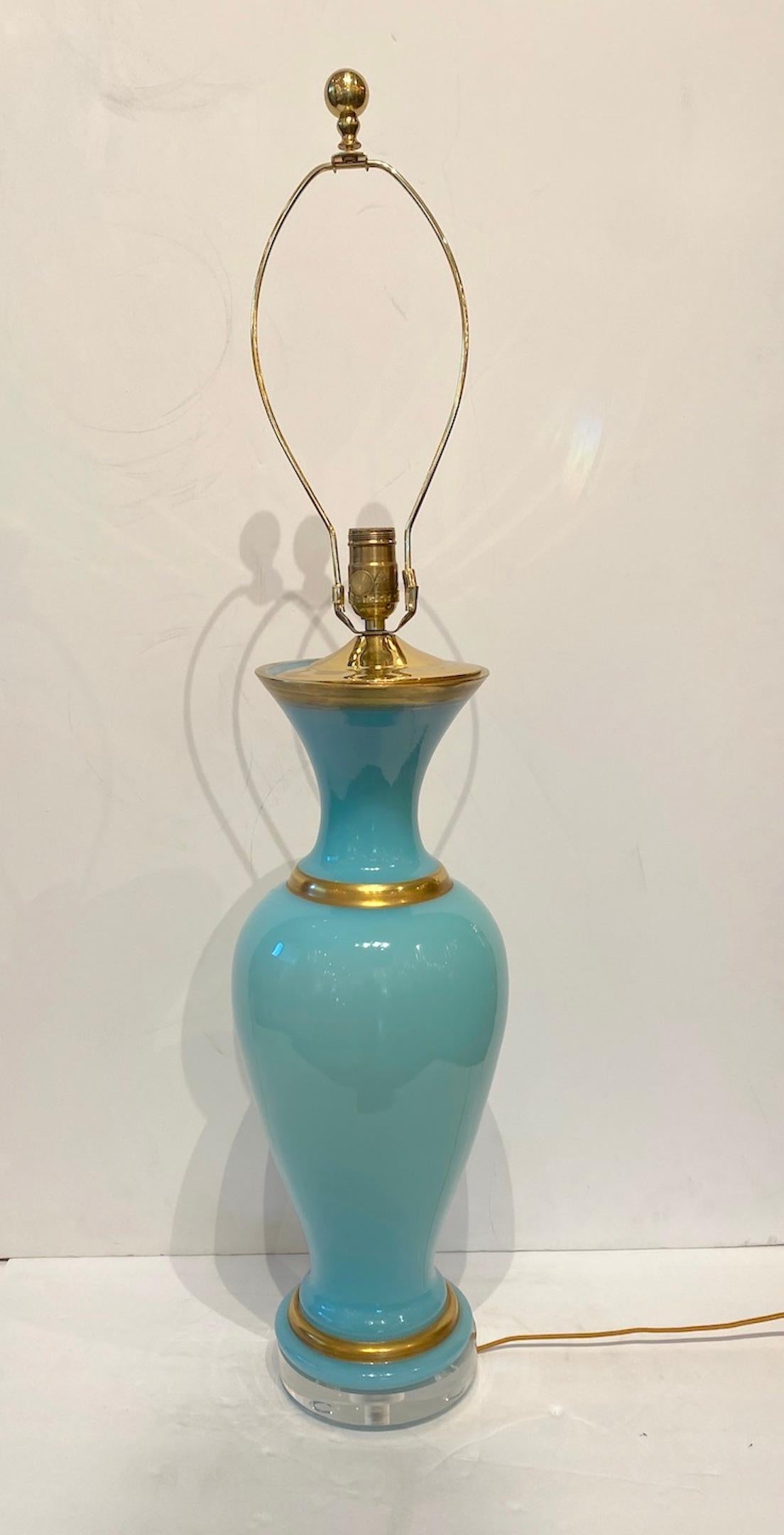 Beautiful pale aqua french opaline vase banded in gold as a lamp. Lucite base. Tan linen shade with trim detail. Wired for USA.
