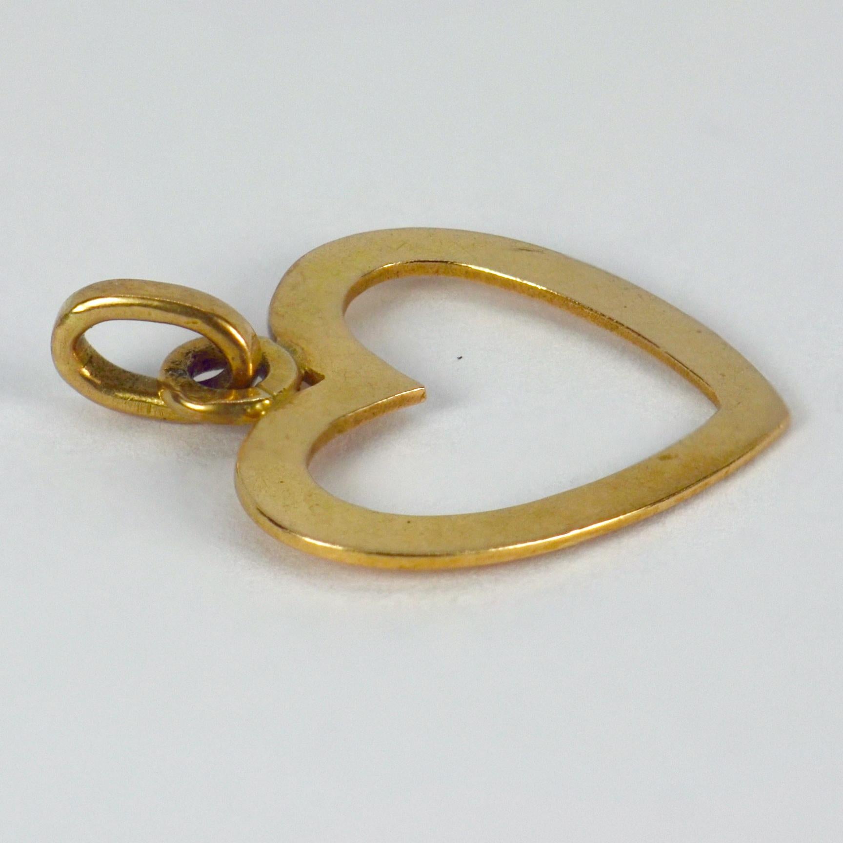 A French 18 karat (18K) yellow gold charm pendant designed as an open heart. Stamped with the French eagle’s head for 18 karat gold along with a partial makers mark.

Dimensions: 1.8 x 1.8 x 0.05 cm (not including jump ring)
Weight: 1.15 grams
