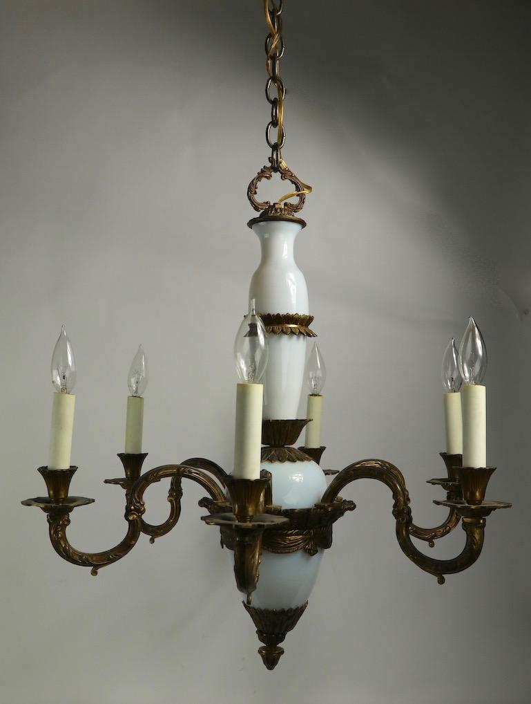 Wonderful classical style six-arm opaline glass and cast brass chandelier. This fine fixture is in very clean, original, and working condition. It accepts standard candle size screw in bulbs, it has been recently rewired, and is ready to