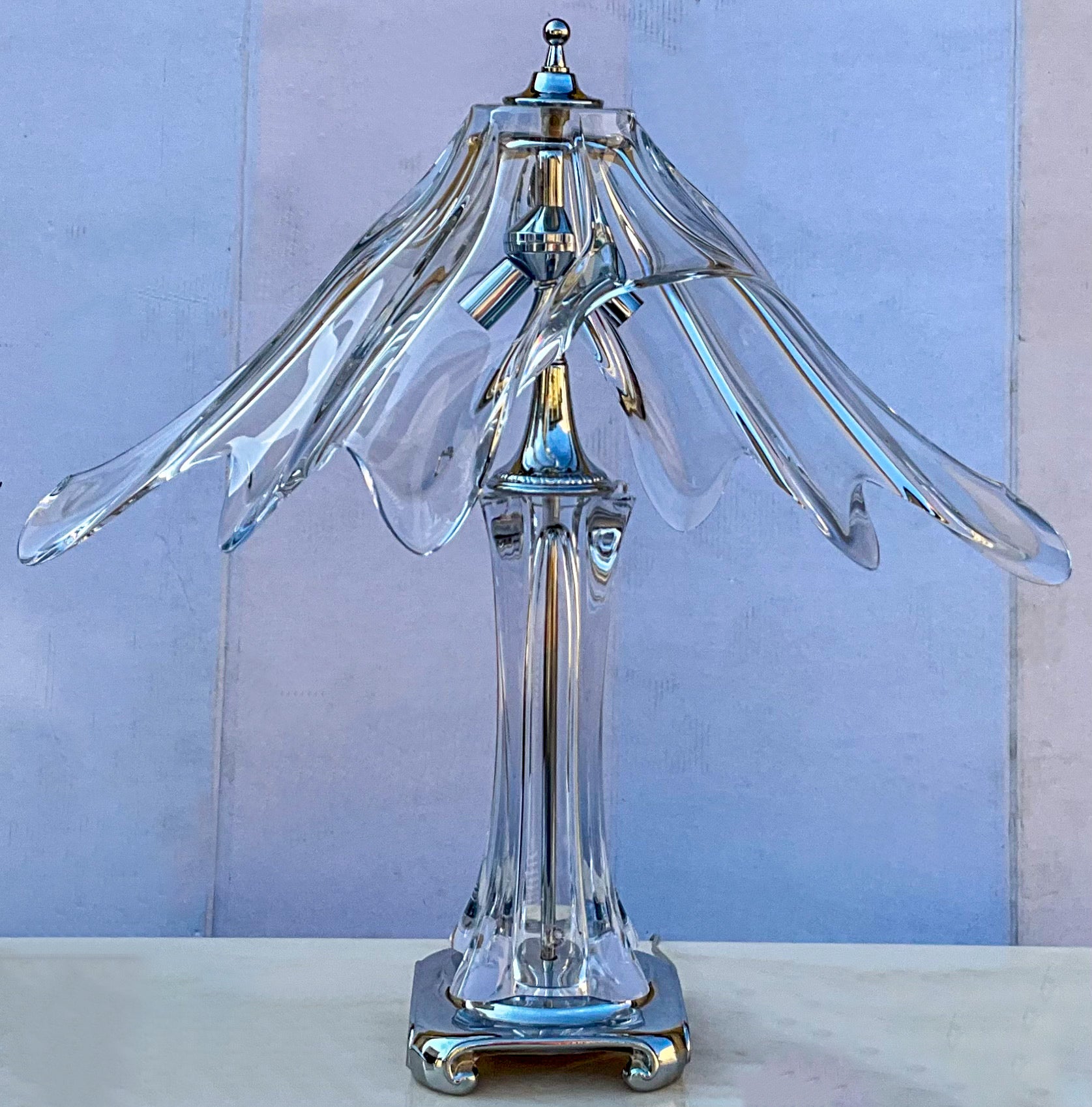 This is a beautiful hand blown crystal and chrome art glass lamp by Cofrac Art Verrier. The lamp accommodates two bulbs. The base is 7” square. It was crafted in France in the 1970s and is in very good condition.