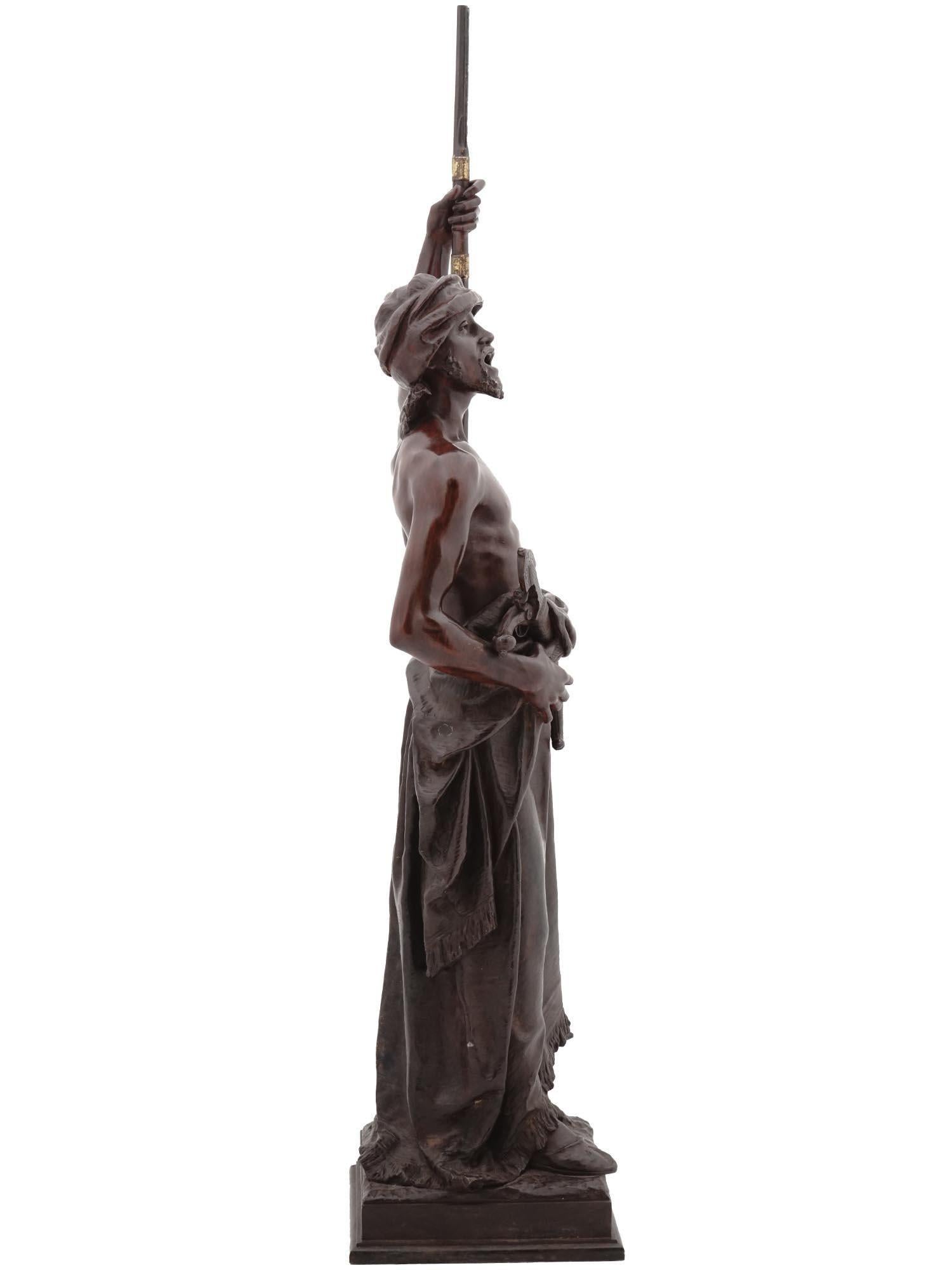 Orientalist patinated and partially gilt bronze sculpture of an Arabian soldier standing guard with rifle after Joaquin Angles (1859-1925).  Signed in the cast.