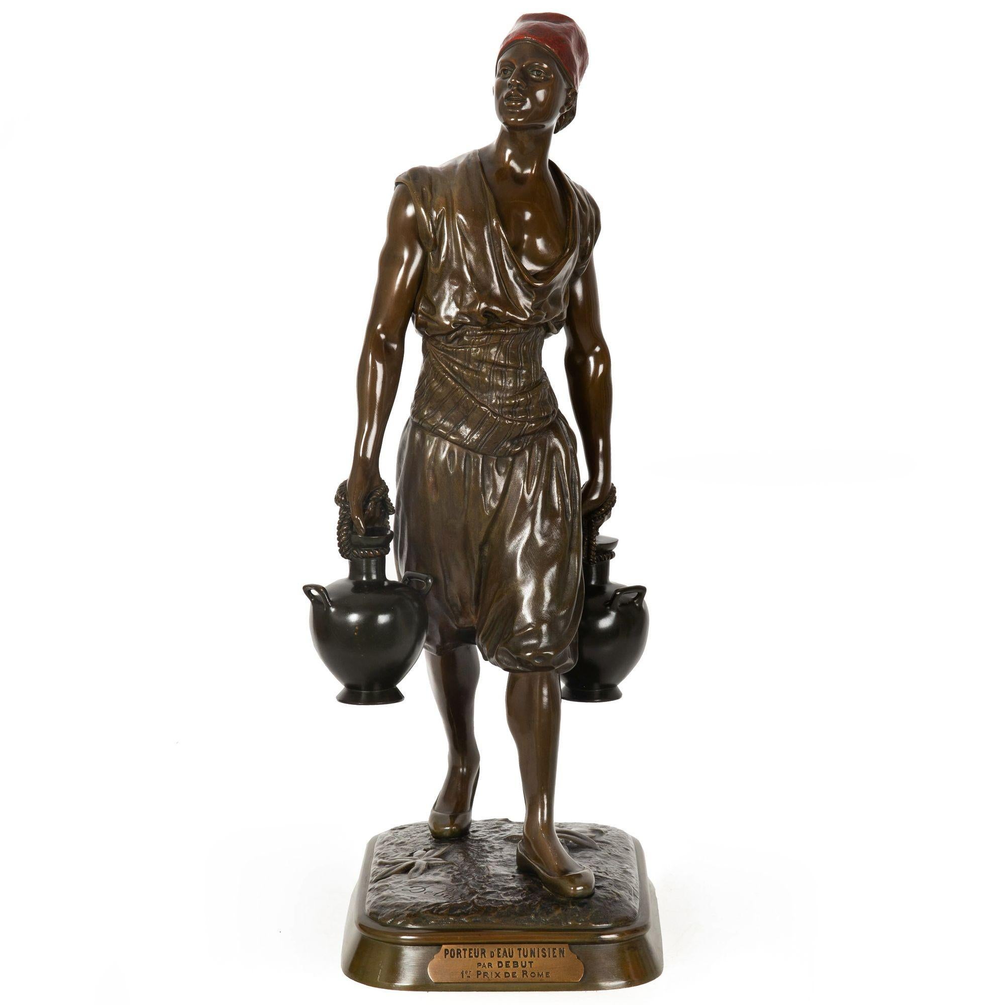 MARCEL DEBUT
French, 1865-1933

French Orientalist Model of a Tunisian Young Man Carrying Water

Polychromed and patinated bronze  signed 