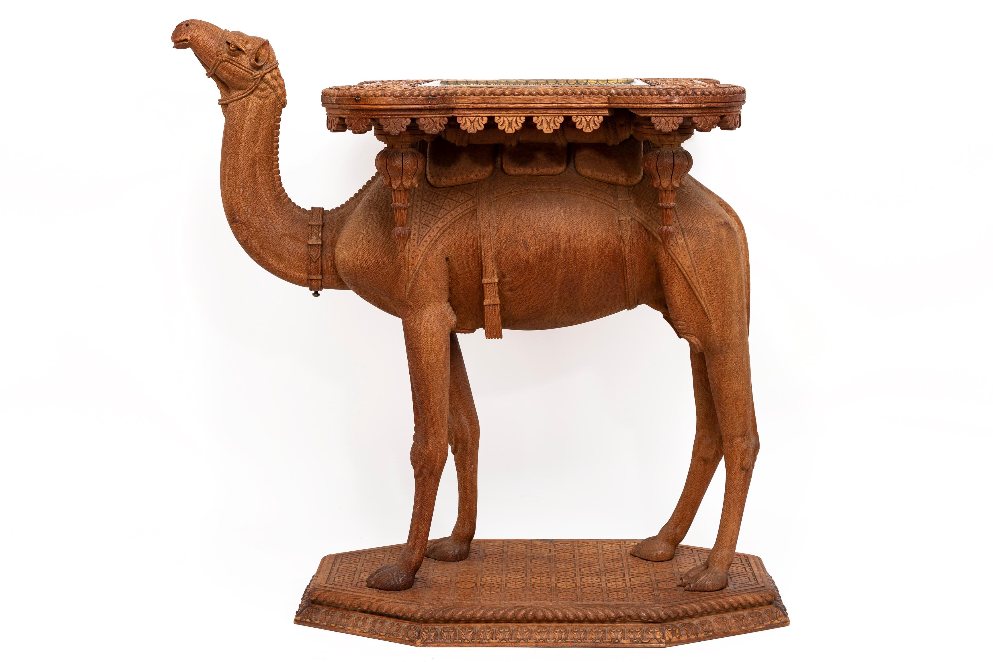 A Marvelous and Quite Impressive French Orientalist Hand-Carved and Hand-Tooled Camel Form Table with a Square Gilt Bronze Top, Attributed to Jansen. This camel table is a testament to the exquisite craftsmanship of orientalist furniture, showcasing