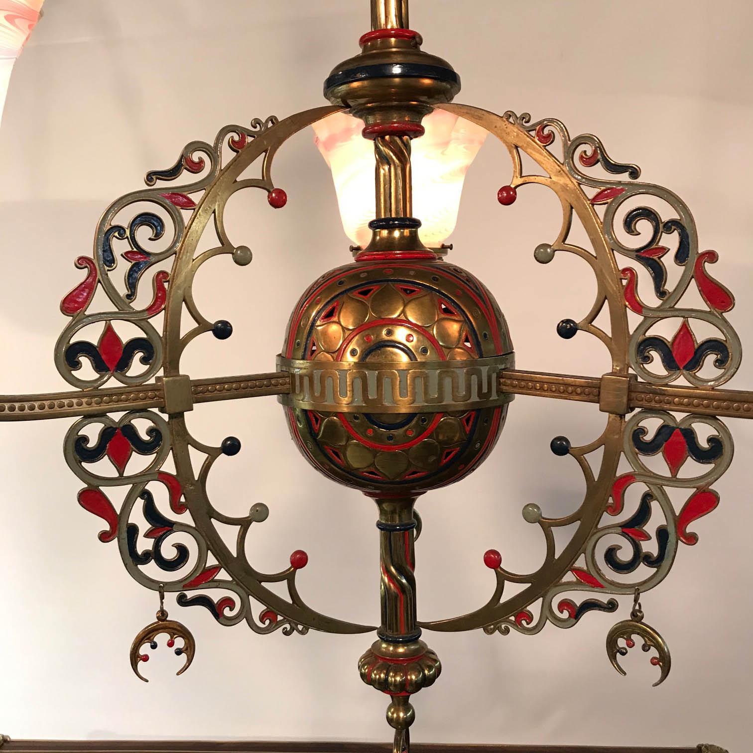 This highly unusual gas fixture has been converted to electricity but in every other respect is unchanged. From a central sphere three arms extend, each with charming original gas cocks modelled as fleurs de lys and hung with pendant crescents. Each