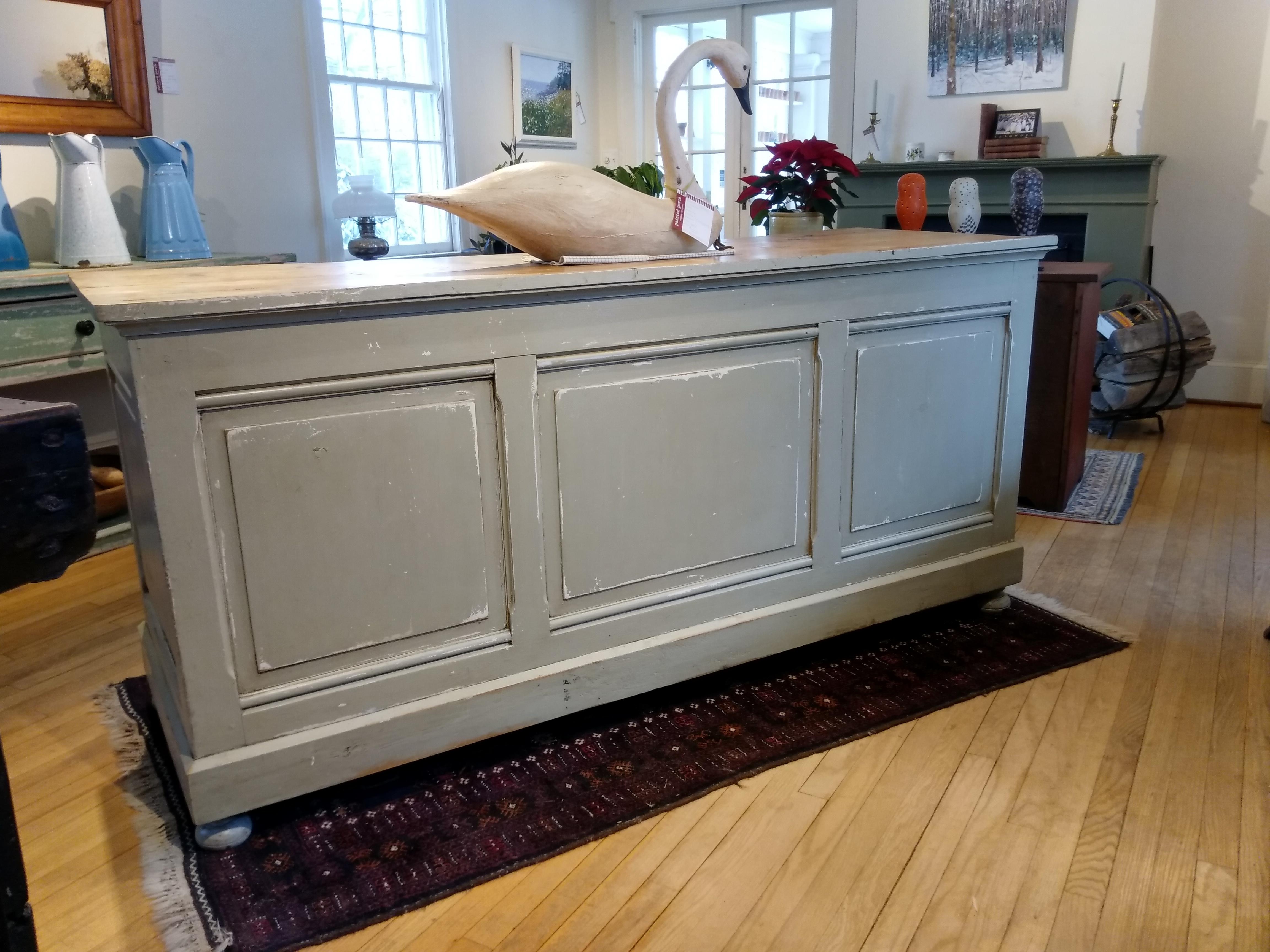 This circa 1880 store counter came from a variety store in the south of France. It has original hardware and three drawers, with a recessed shelf on the bottom for lots of storage. The base is painted a soft French blue-grey, and the other three
