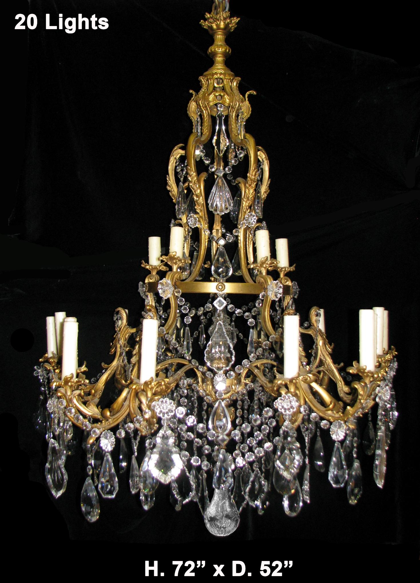 Spectacular large French Louis XV style ormolu and fine cut crystal two-tier twenty light chandelier,
19th century.

The chandelier is surmounted with a gilt bronze flame, above a central shaft issuing five laurel leaf decorated supports, the top