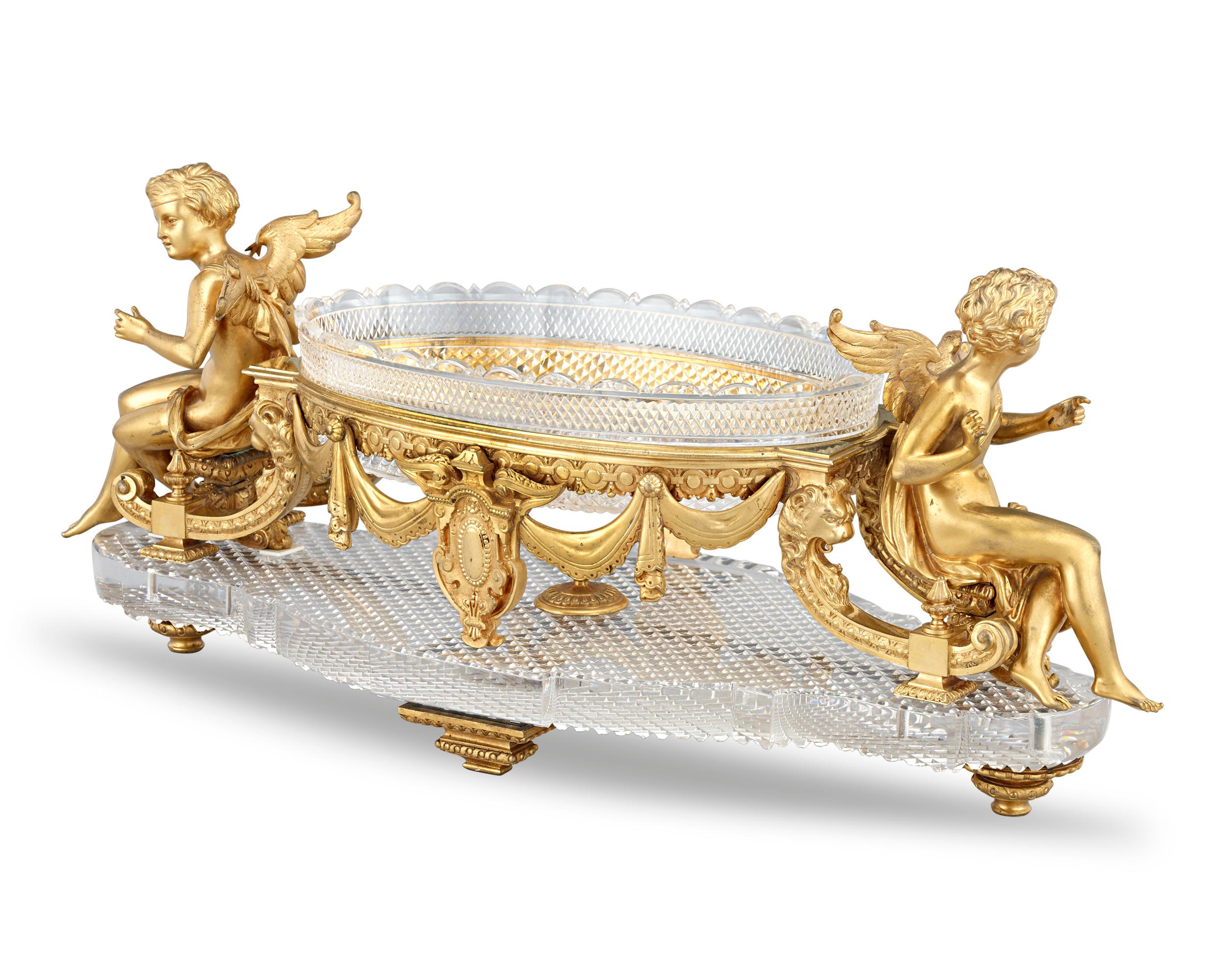 This French ormolu and cut glass table garniture by the famed Baccart displays the exceptional workmanship for which this legendary firm is renowned. The garniture comprises five pieces: a surtout de table, two candlesticks and two tazze. From the