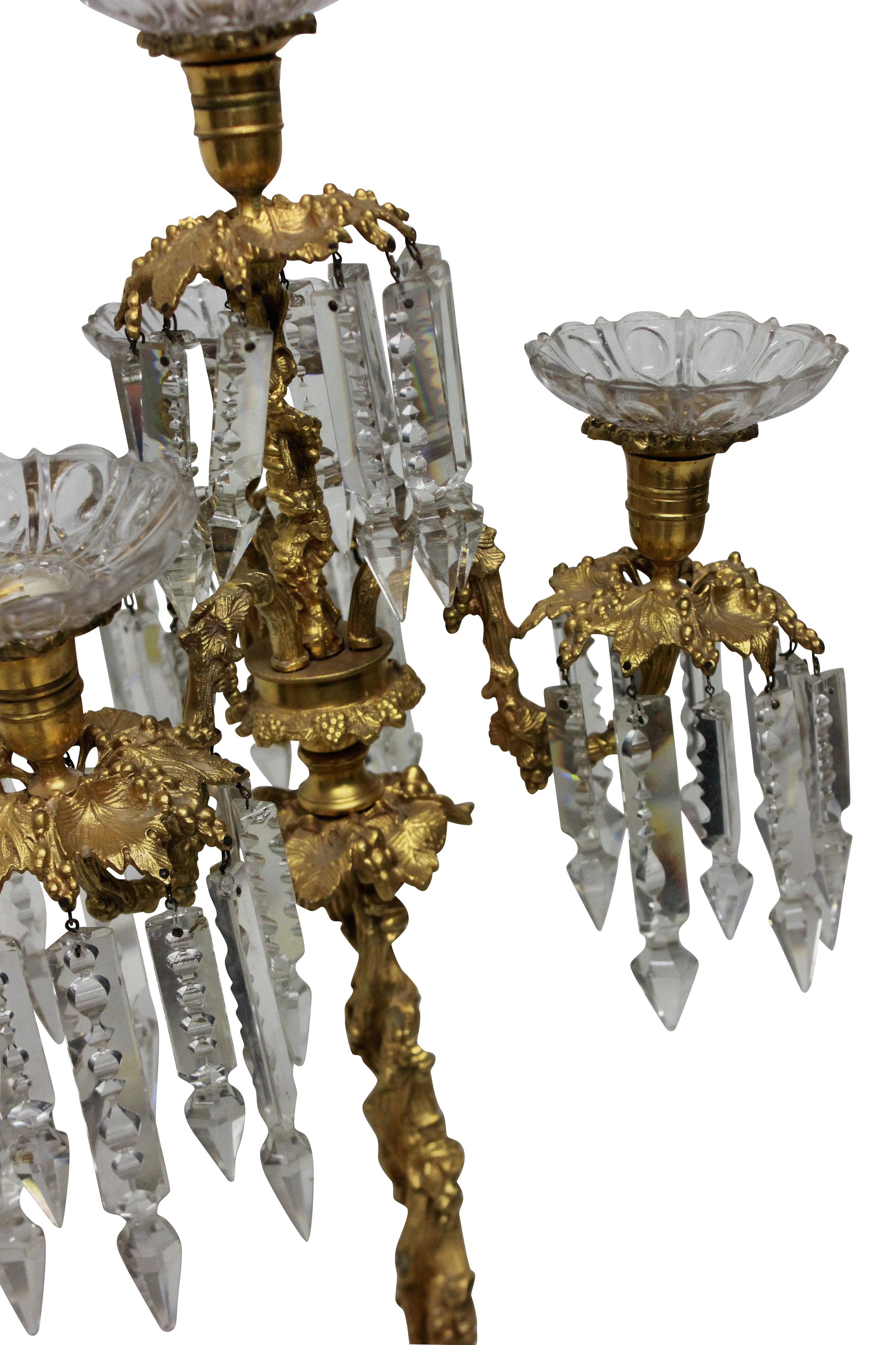 A French ormolu and glass candelabrum, the ormolu depicting vines.

  