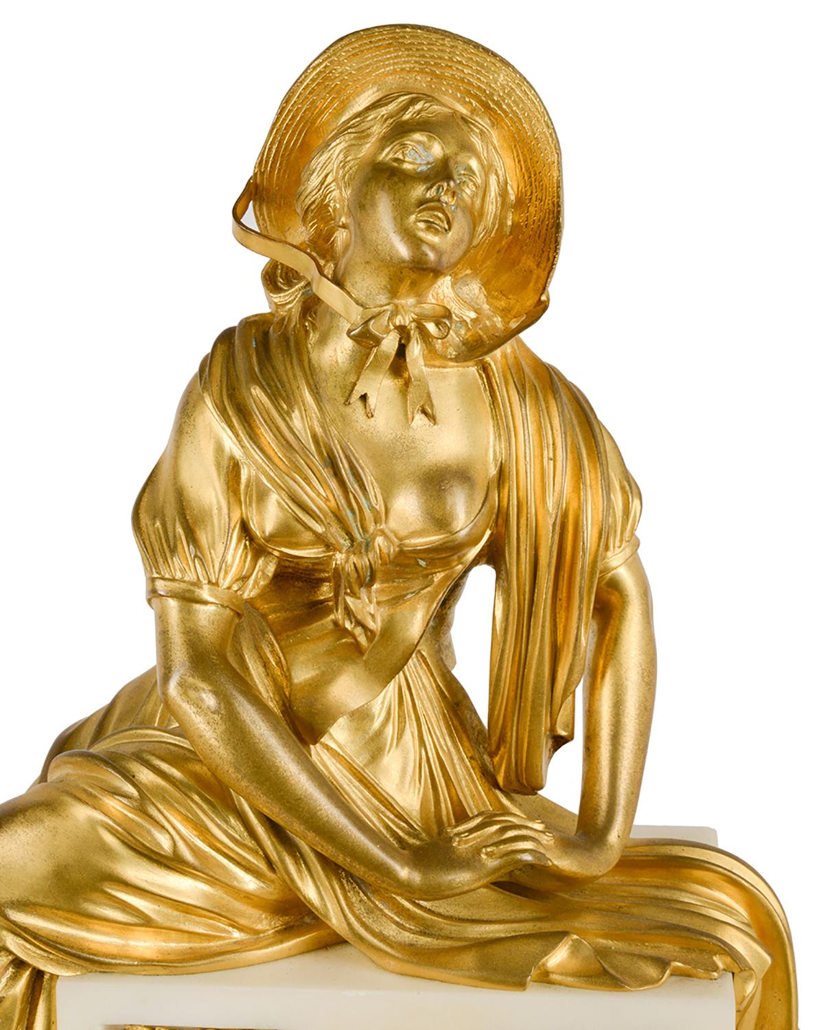 A very good quality 19th century French gilded Ormolu and white marble mantle clock, Having a seated young maiden with a bonnet, above the white enamel clock face, the clock strikes on the hour and half hour. An Ormolu cherub knelling by a broken