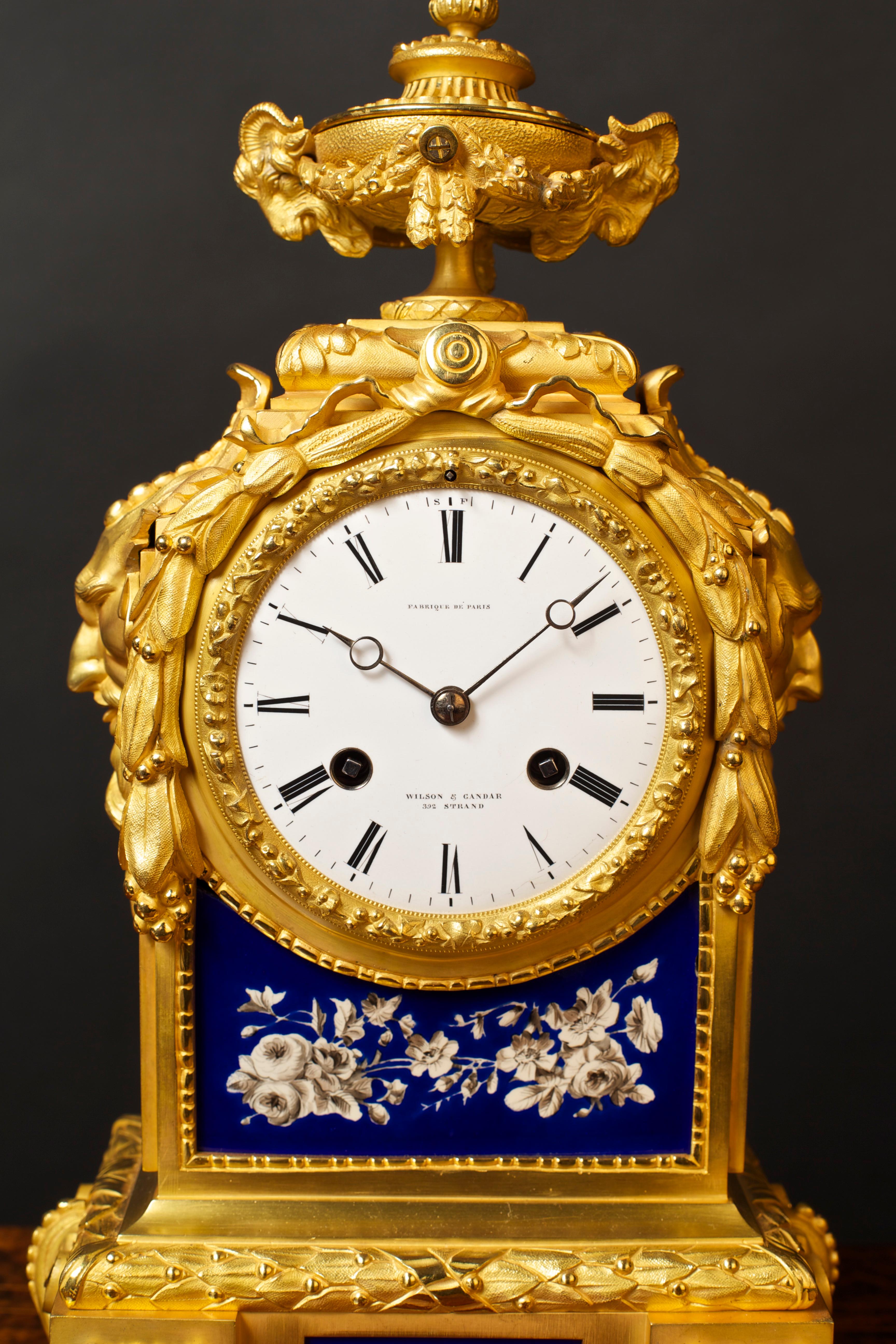 French gilded ormolu mantel clock with blue hand painted floral porcelain panels (the panels all separately signed ‘Creilliet Montereai, Medaillon D’or, L.M. Cie 1834-38). Beautifully decorated case with applied ormolu mounts, floral swags to each