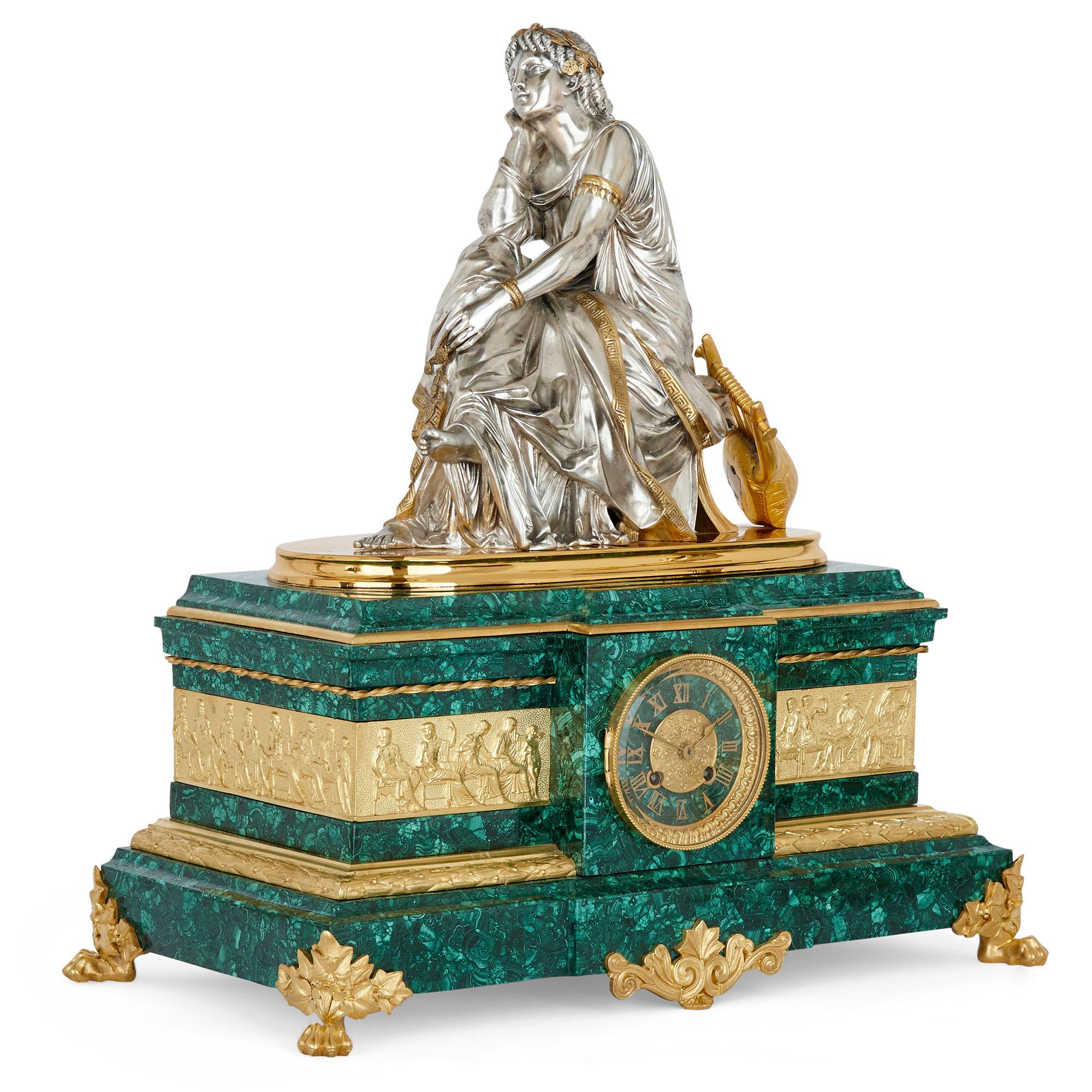 French ormolu and silvered bronze mounted malachite three-piece clock set
French, late 19th century
Clock: Height 56cm, width 53cm, depth 28cm
Candelabra: Height 66cm, width 30cm, depth 30cm

This fine three-piece clock set is wrought from gilt
