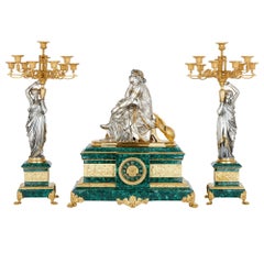 French Ormolu and Silvered Bronze Mounted Malachite Three-Piece Clock Set