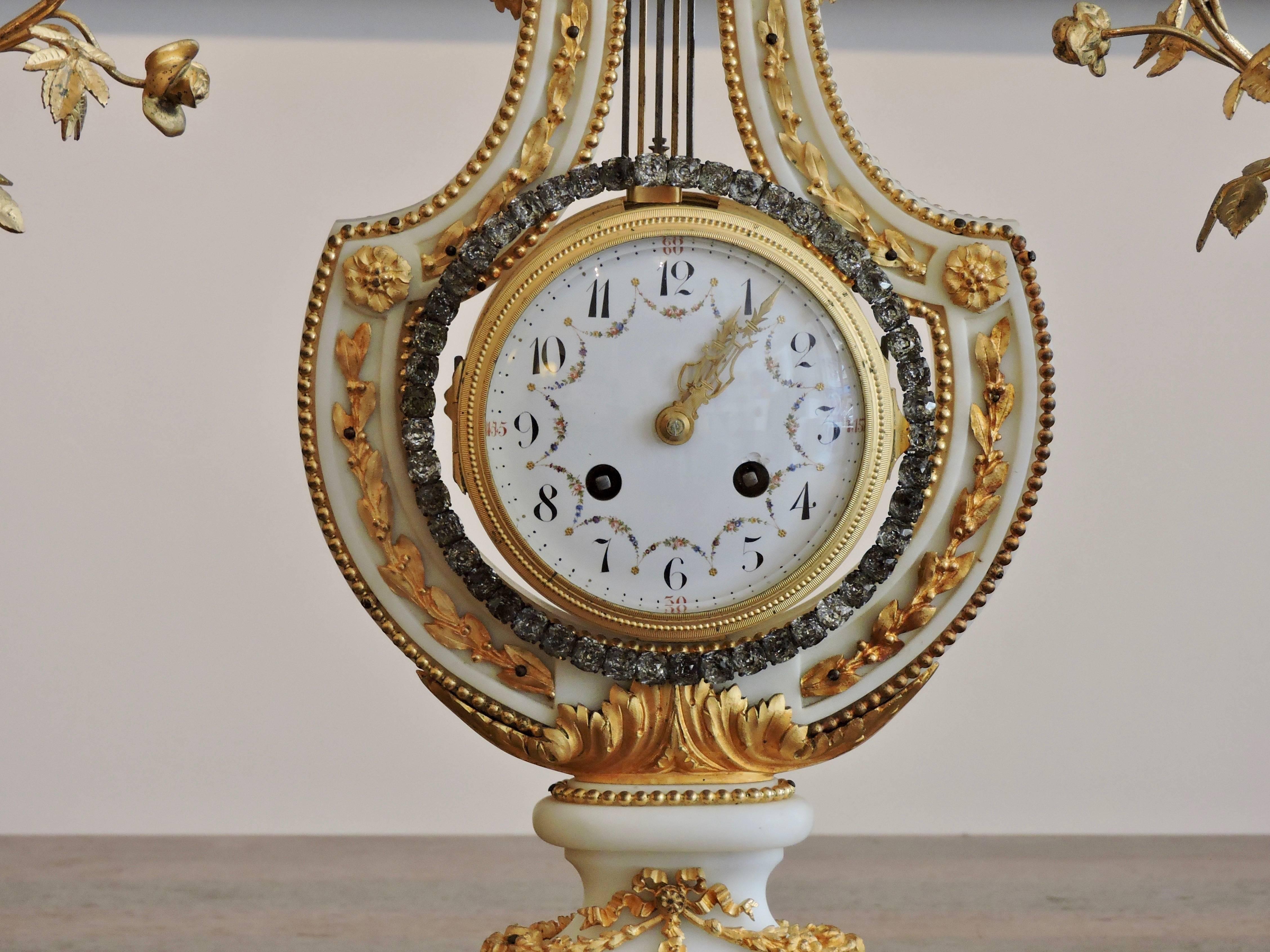 Gilt French Ormolu and White Marble Three-Piece Lyre Shaped Clock Garniture