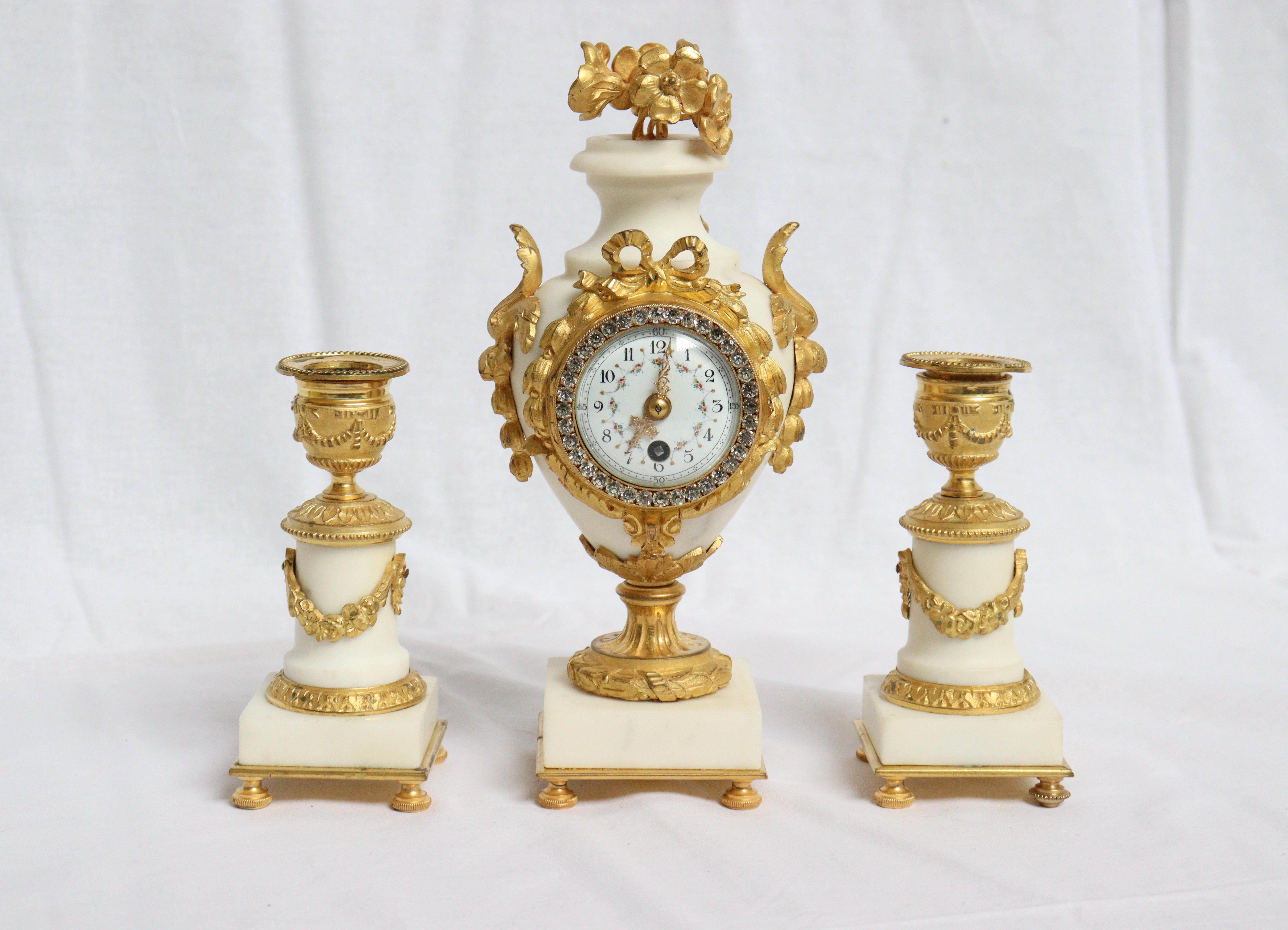 French Ormolu and White Marble Three-Pieces Vase Shaped Clock Garniture