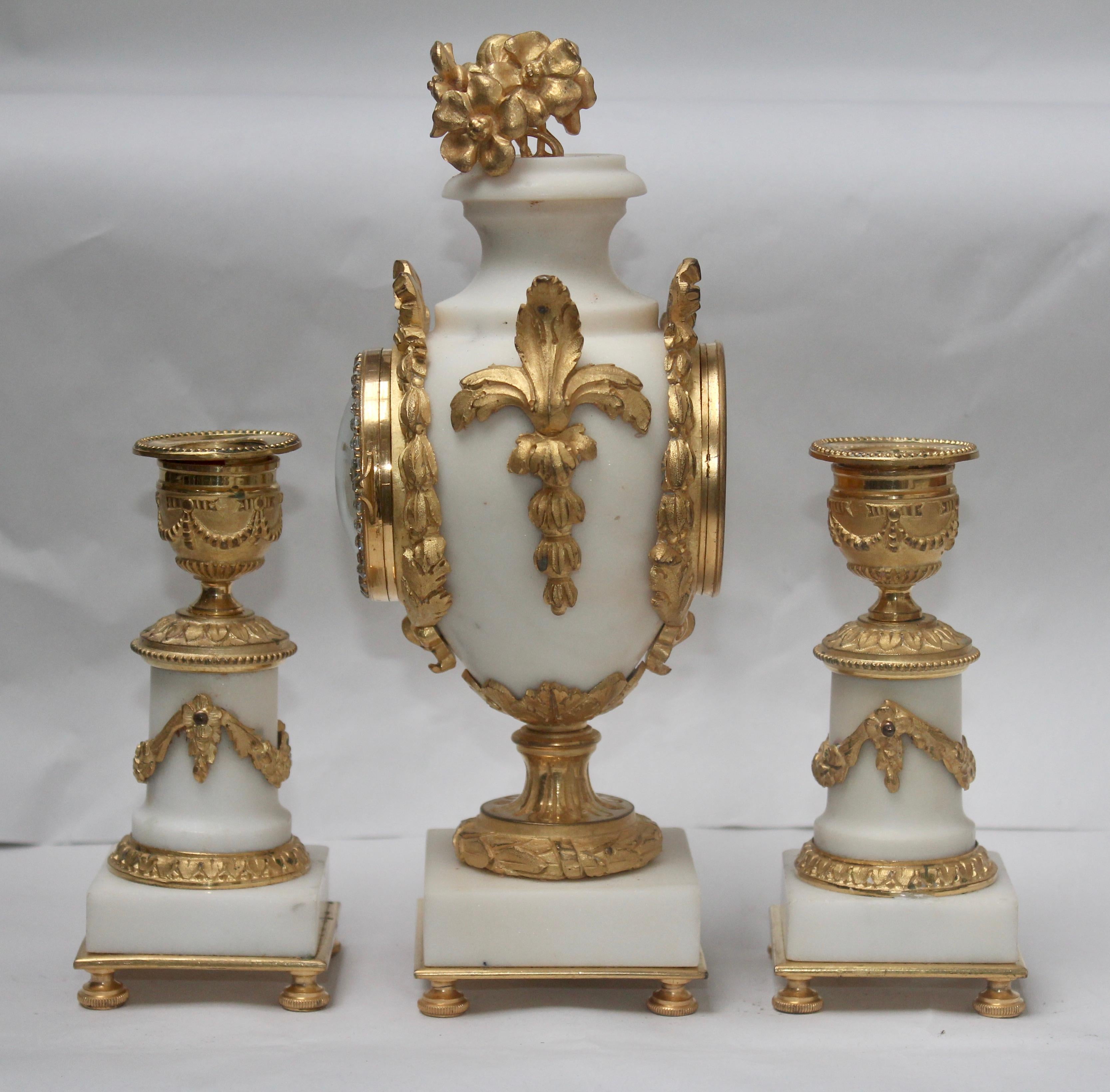 Louis XVI French Ormolu and White Marble Three-Pieces Vase Shaped Clock Garniture