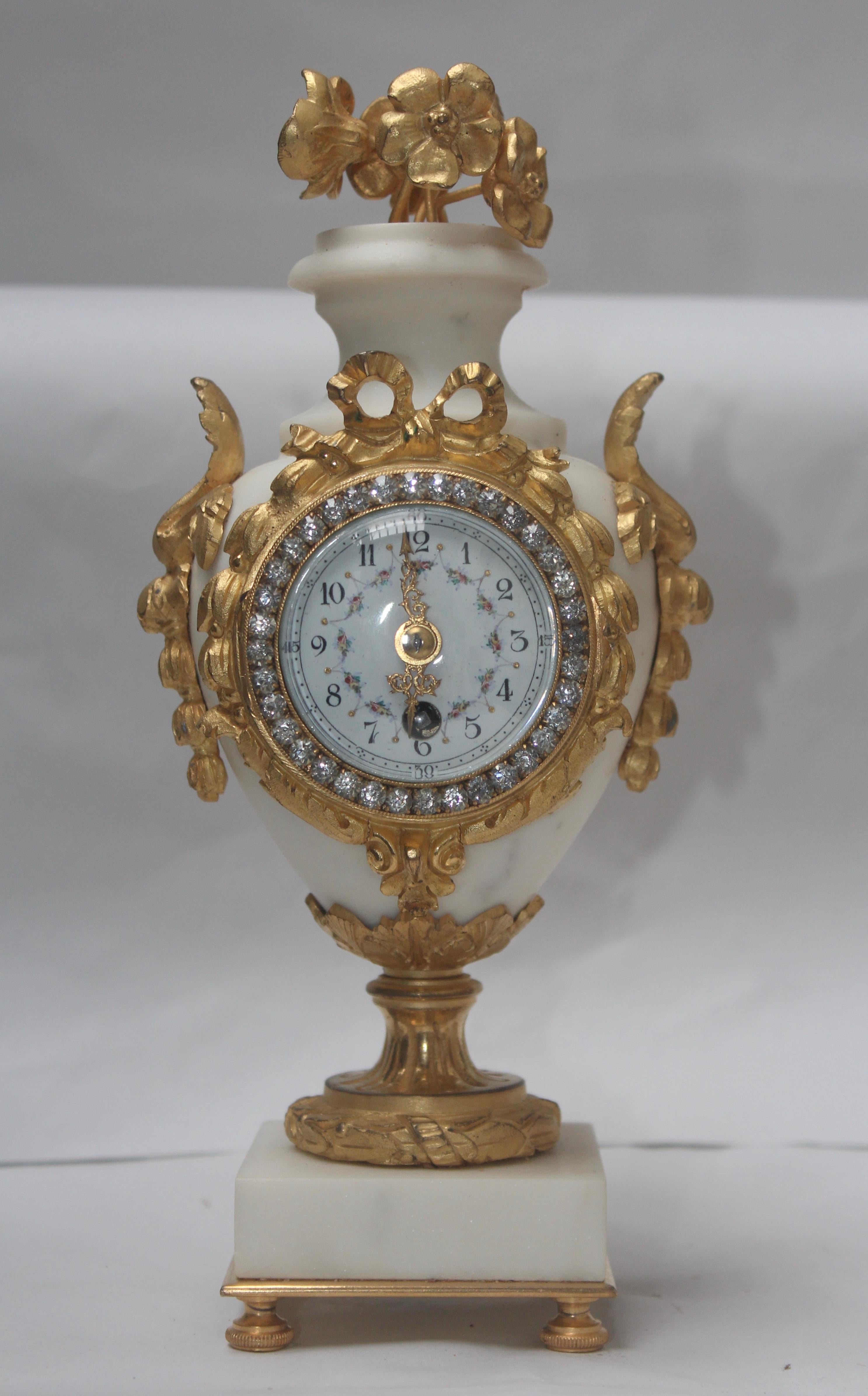 French Ormolu and White Marble Three-Pieces Vase Shaped Clock Garniture 1